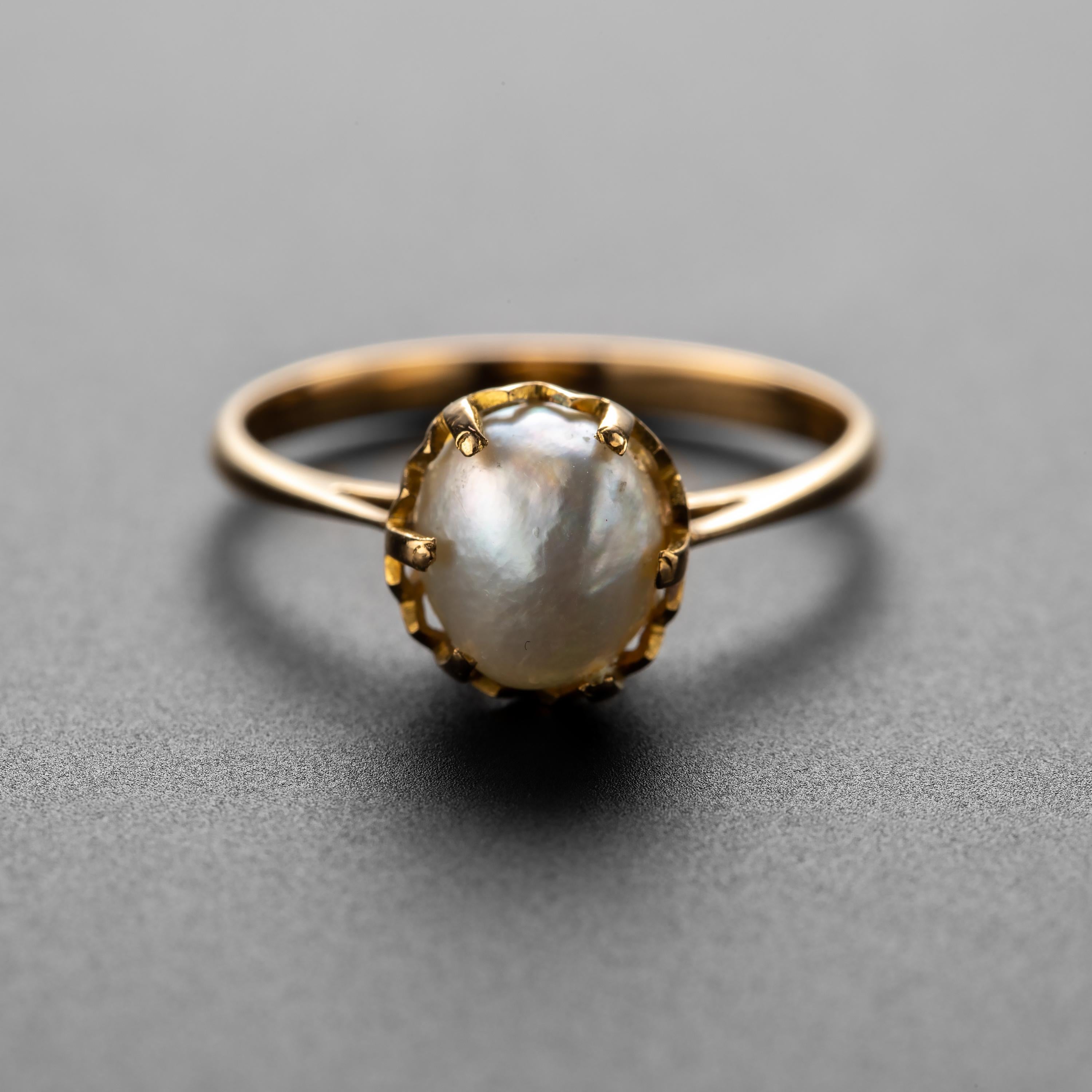 A glorious, pure, and natural uncultured and undrilled saltwater pearl resides within the secure grip of regal prongs in this fabulous ring from the late Victorian era (circa 1900). Purchased in England but bearing no hallmarks, this 18K yellow gold