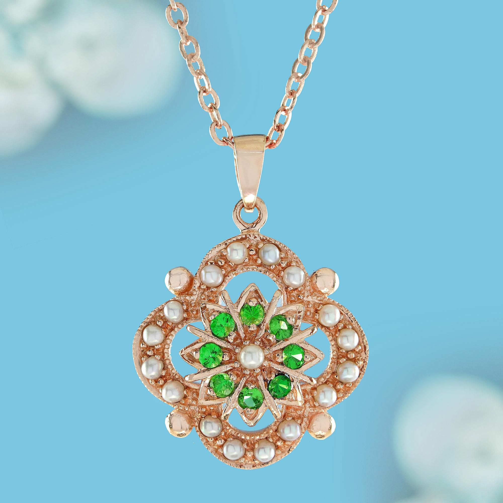   Encased within a vintage Victorian-style yellow gold frame, this distinctive pendant showcases a captivating design.  The delicate curved yellow gold openwork pendant features seed pearl in the center, surrounded by a frame of round emerald and