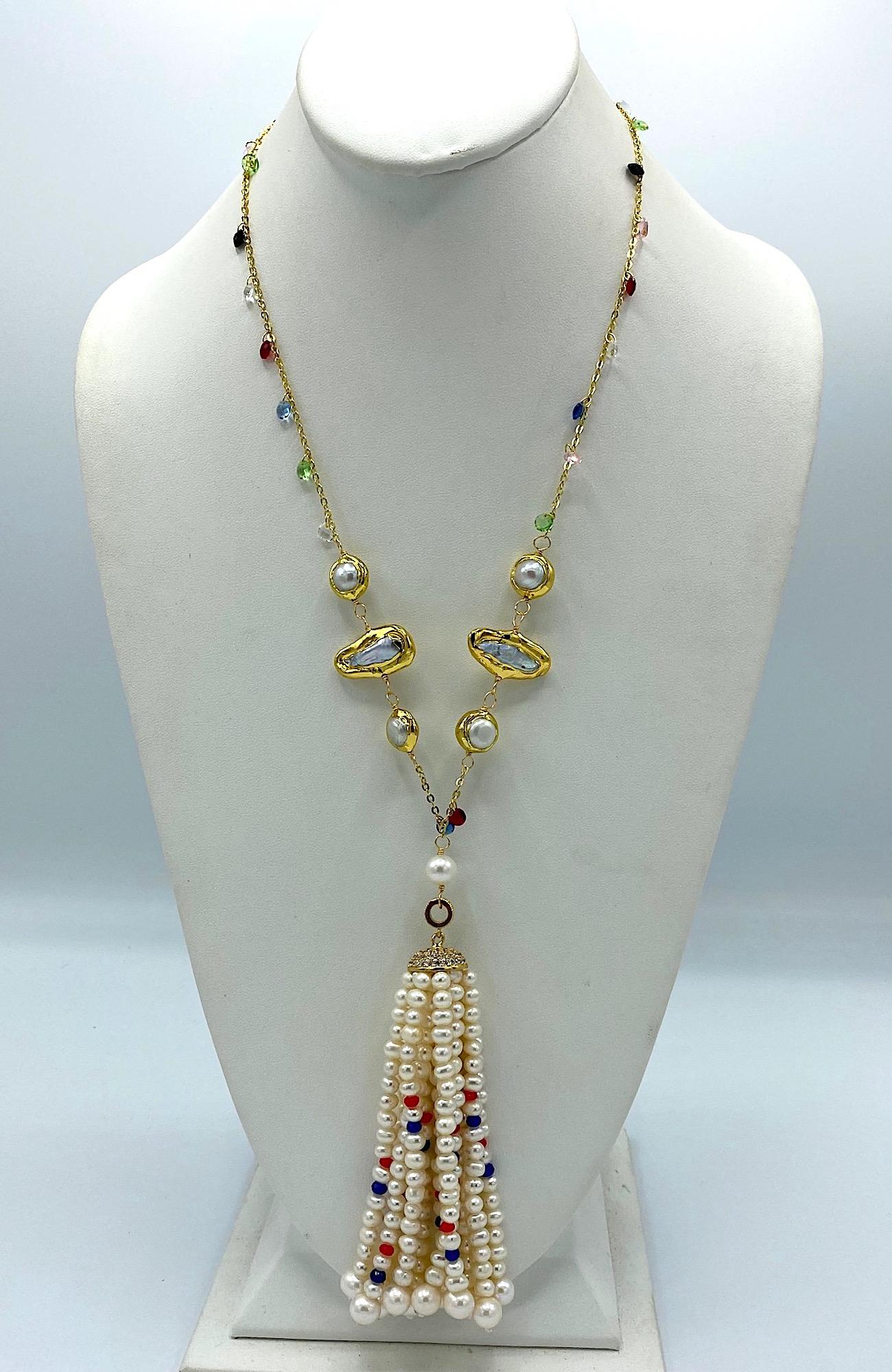 A wonderful and fun natural pearl tassel pendant necklace. The necklace has a 24.5 inch long fine gold plate chain with 28 faceted briolette multi color crystals. Additionally, there are four round and two long natural fresh w water Biwa Pearls set