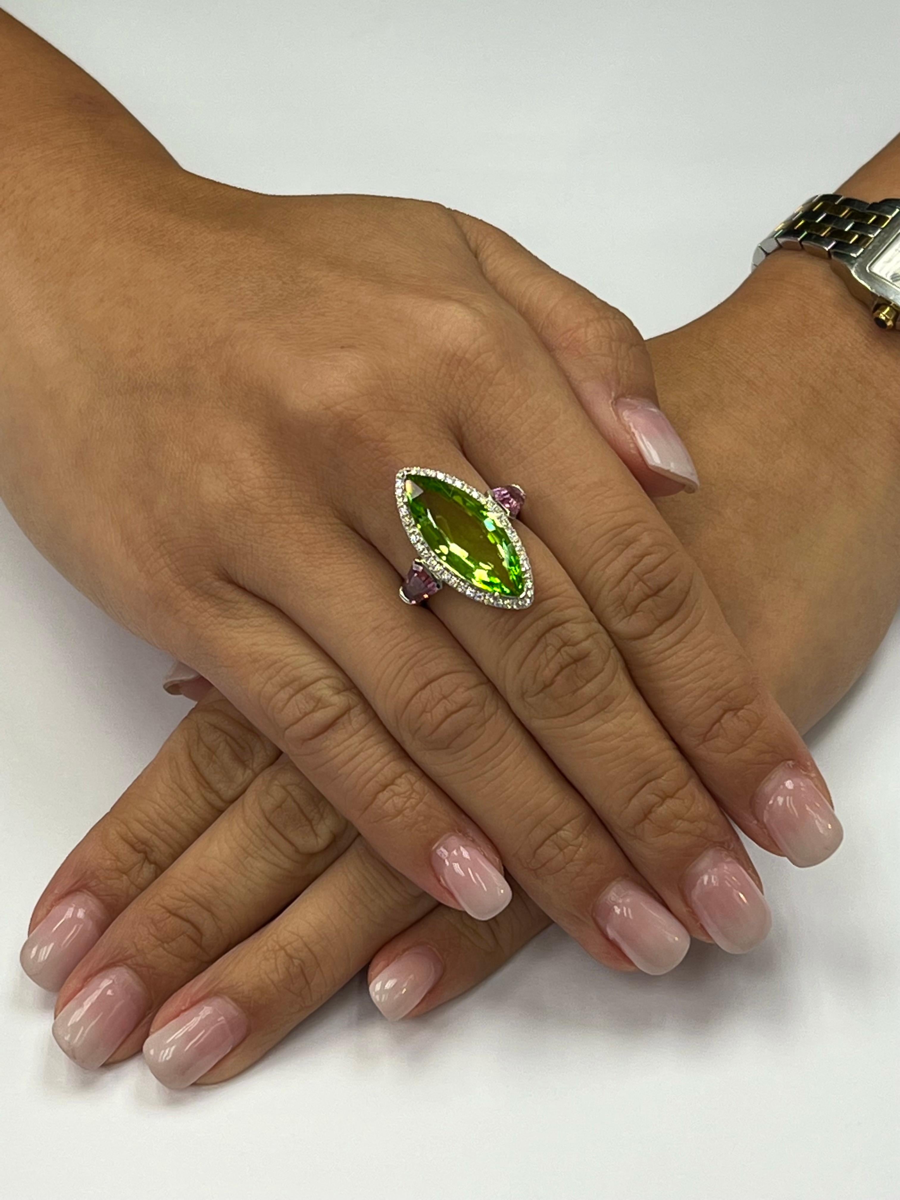 Please check out the HD video! This Peridot came straight from the source in Burma. This natural Peridot is not treated or enhanced. The ring is set in 18k white gold. The center Marquise shaped Peridot is 7.38cts. There are 2 special cut natural
