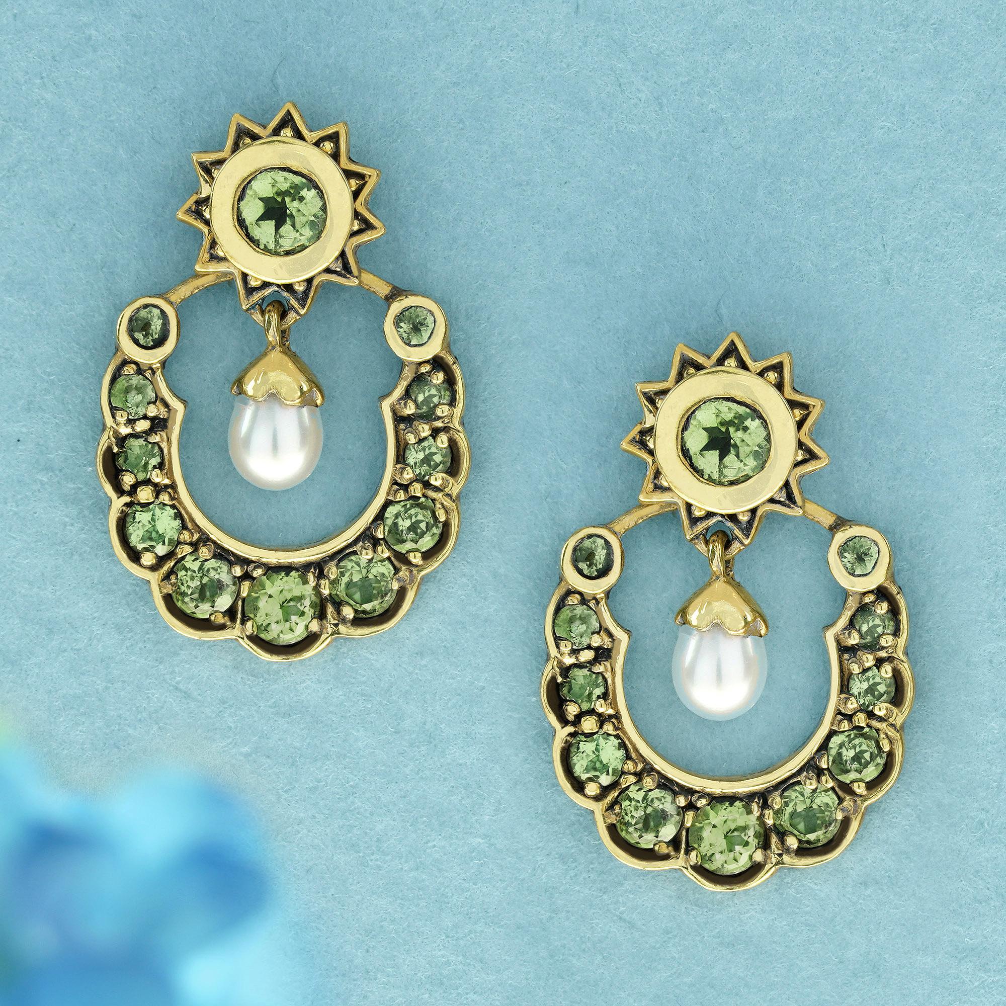  Crafted from yellow gold, this graceful vintage-inspired drop earrings showcase a verdant, a round white pearl in a striking trillion shape, serving as the centerpiece of the pieces . Encircling the pearls are round lime green peridots delicately