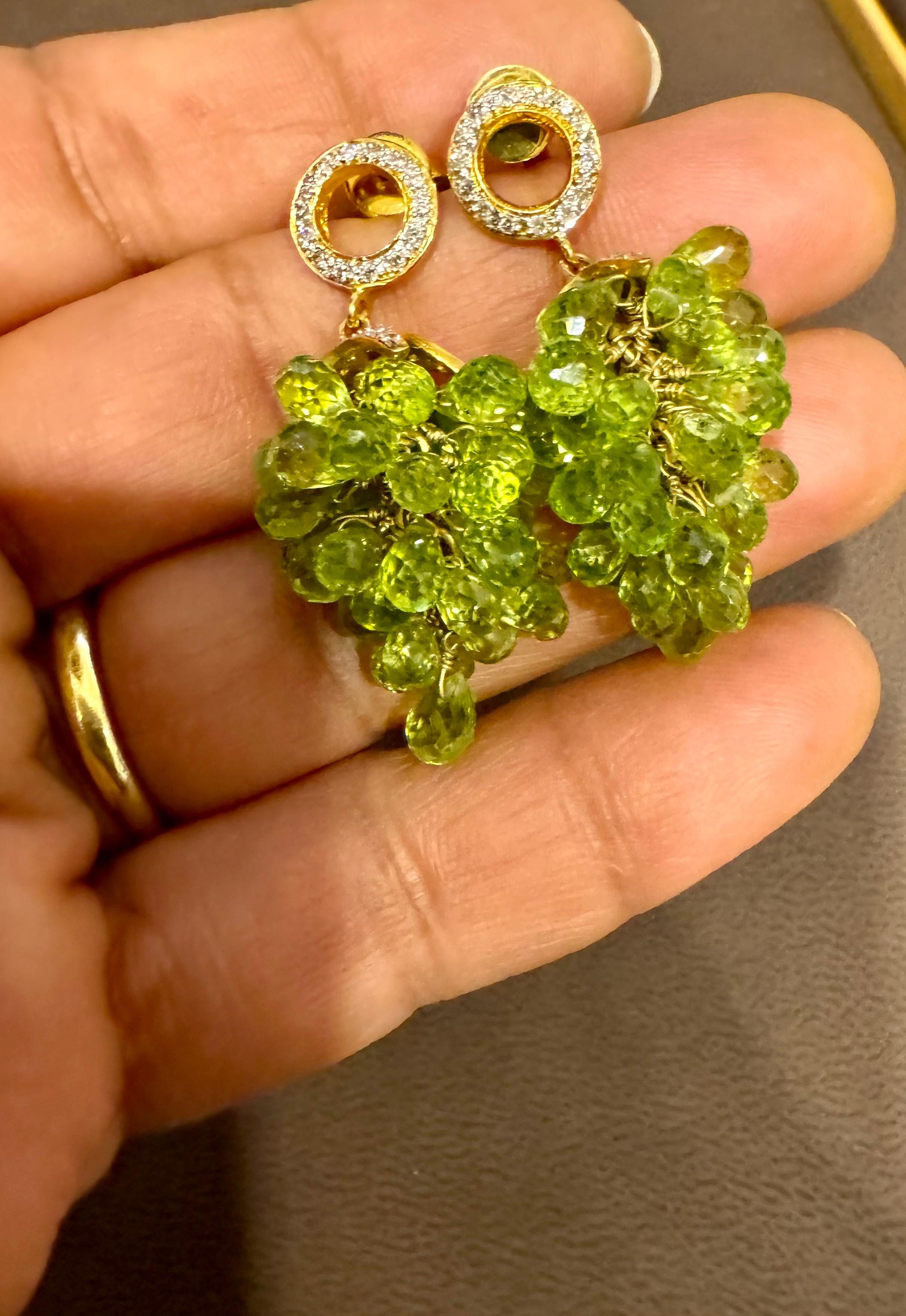 Approximately 40 Carats of natural Peridot  Briolettes & Diamond  Hanging Earrings  18 Karat  Gold 
This exquisite pair of earrings are beautifully crafted with 18 karat yellow gold  weighing 15.5 grams

Brilliant cut diamonds are making a circle