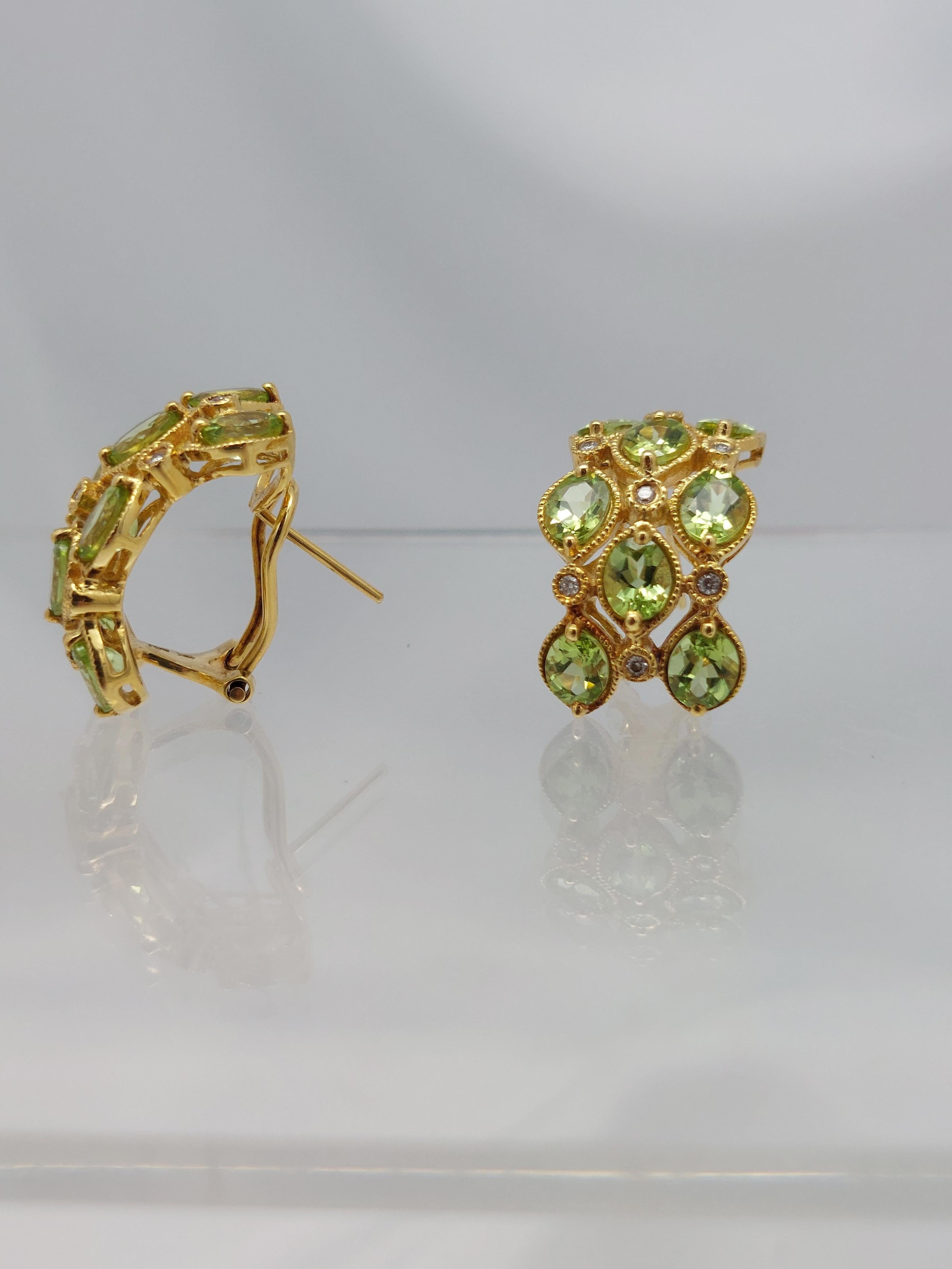 Ear Hugging Sparklers………………………

18 karat yellow gold Earrings with Bright Peridot and Diamonds
Earrings measure  20.00 mm.  x  15.00 mm. wide with Post and omega backs.
Sixteen (16) Marquise shape Brilliant Cut Peridot measuring  7.00  x  5.00 mm.