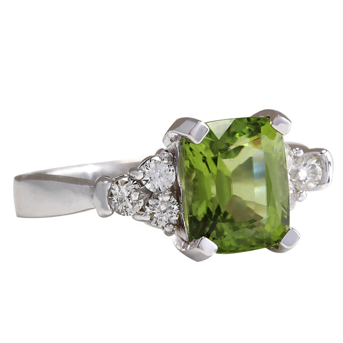 Introducing our exquisite 3.38 Carat Natural Peridot Ring, delicately crafted in 14K White Gold. This stunning piece showcases a captivating peridot gemstone weighing 3.03 carats, measuring 9.00x7.00 mm, exuding its vibrant green hue. Accentuating