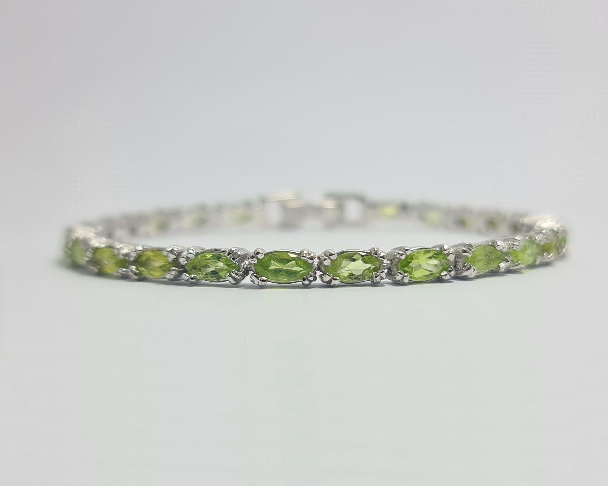 Natural Peridot Marquise Cut Pure .925 Sterling Silver Rhodium Plated Tennis Bracelet 

Length: 7 inches
Carats: 15 cts
Total weight of the bracelet: 13 grams