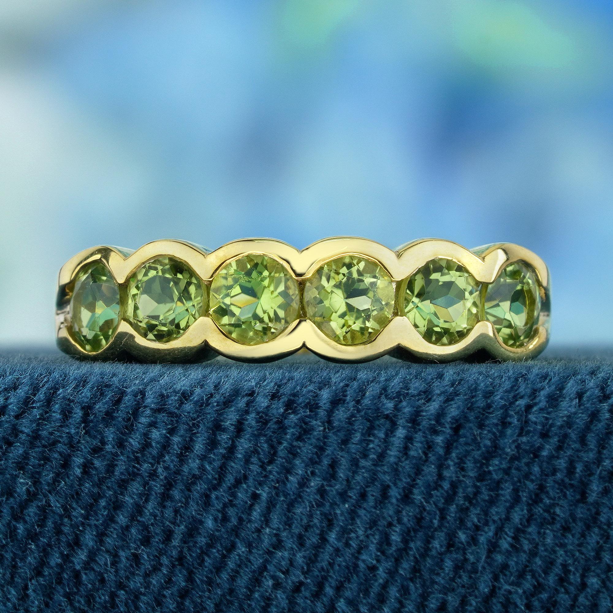 The ring features a vintage style. Its yellow gold setting provides a cozy and opulent base for the gemstones. Nestled at the core of the ring are half eternity of natural lime green peridots, emanating a vibrant charm. A stunning addition to any