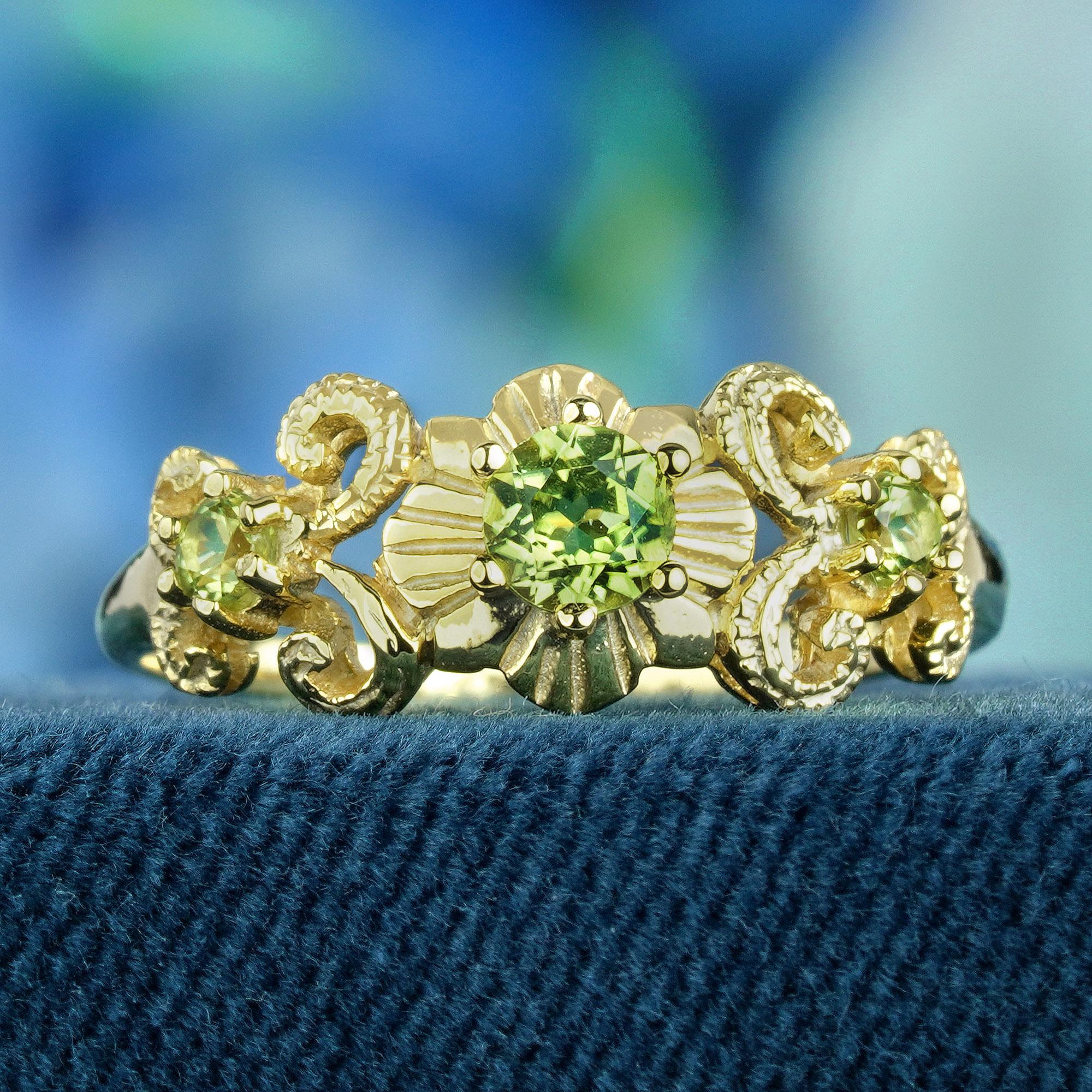 This vintage-inspired ring radiates elegance, boasting intricate carved and curled detailing that accentuates its beauty. Featuring three round lime green peridots set delicately in prongs on a yellow gold band, its design exudes timeless charm.