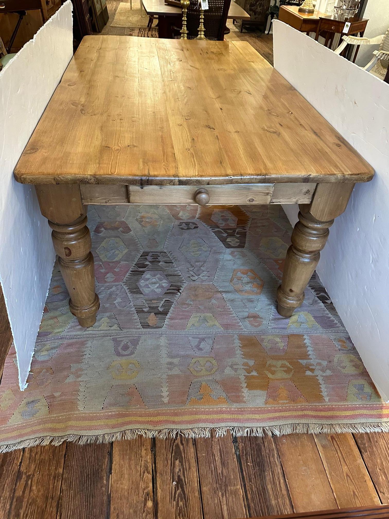 Warm and welcoming natural pine farm table having fabulous chunky turned legs and a drawer at each end. 
apron is 5