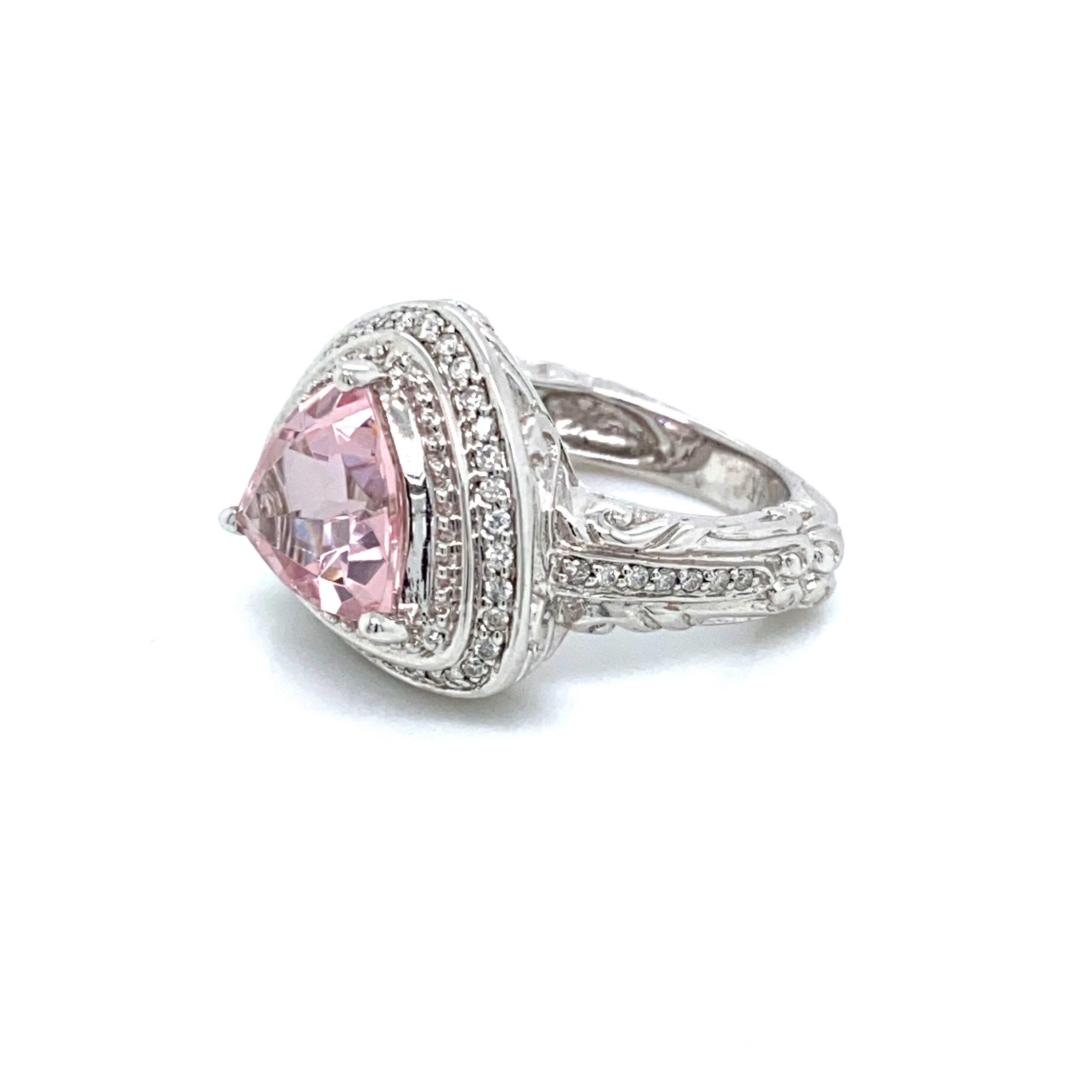 This is a gorgeous natural morganite and diamond halo vintage ring set in solid 14K white gold. This ring features a  natural 2.34 Ct trillion cut pink morganite which has an excellent royal pink color (AAA quality gem) and is surrounded by a double