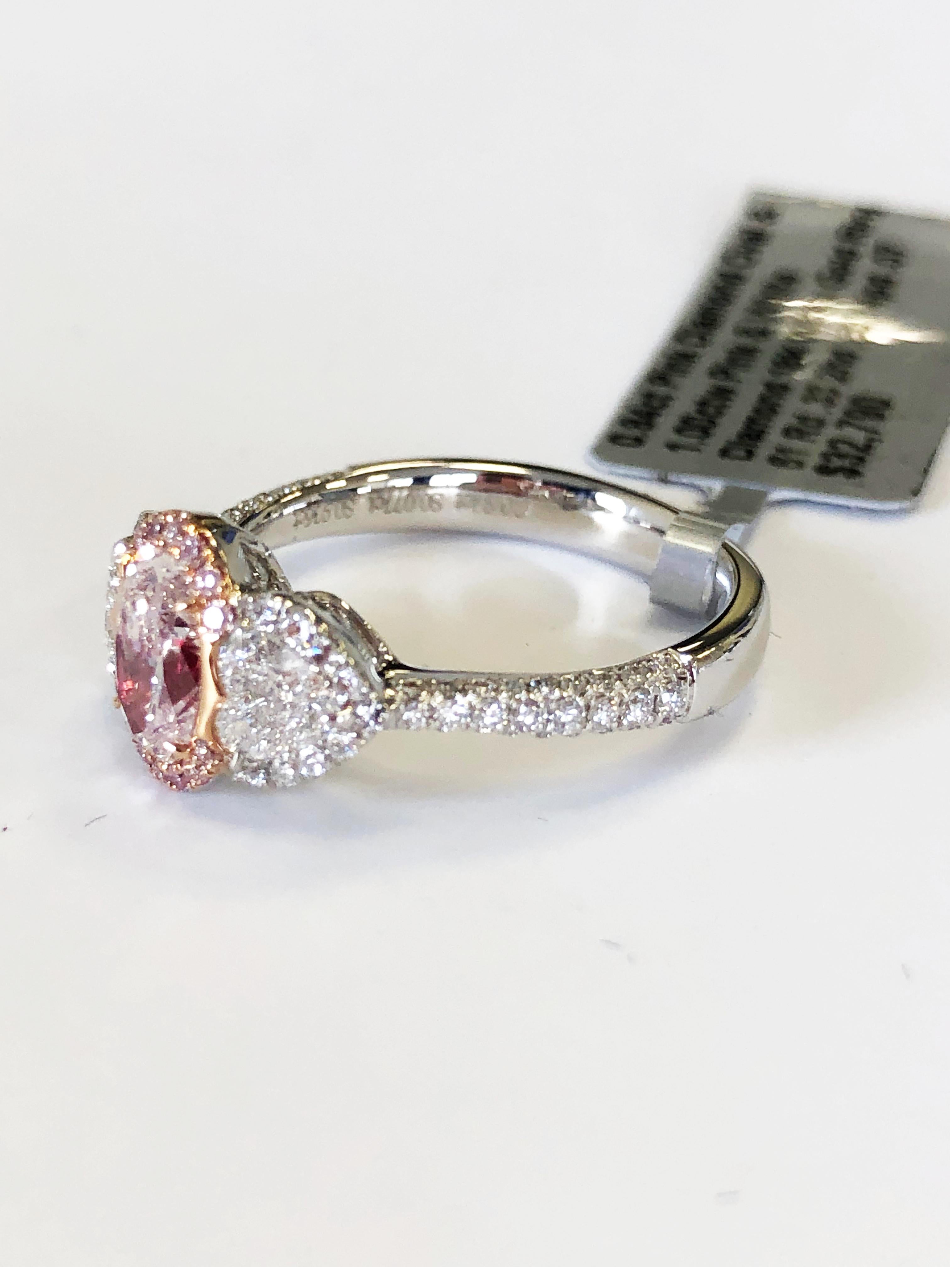 Gorgeous natural pink and white diamond cocktail ring. This ring features a perfectly rose pink oval diamond that weighs 0.84 carats with 1.00 carats of pink and white diamond accent stones. Handcrafted in 18k white gold, this ring is a stunner!