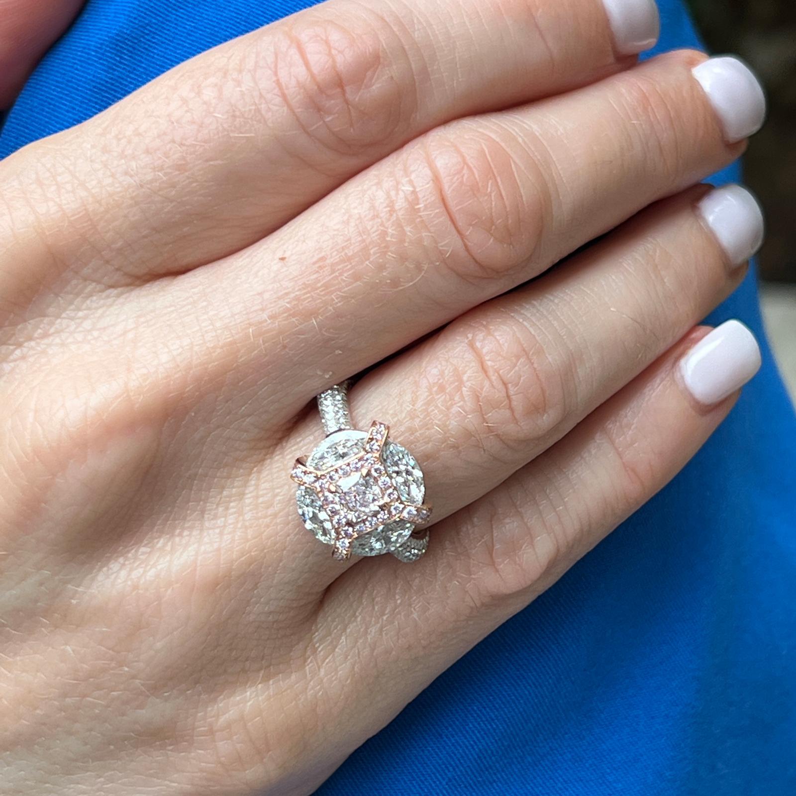 Fabulous natural pink diamond engagement ring fashioned in 18 karat white and rose gold. The ring features a .45 carat radiant cut natural light pink diamond graded by the GIA VLP/SI1 (see report in the photos section). The pink diamond is