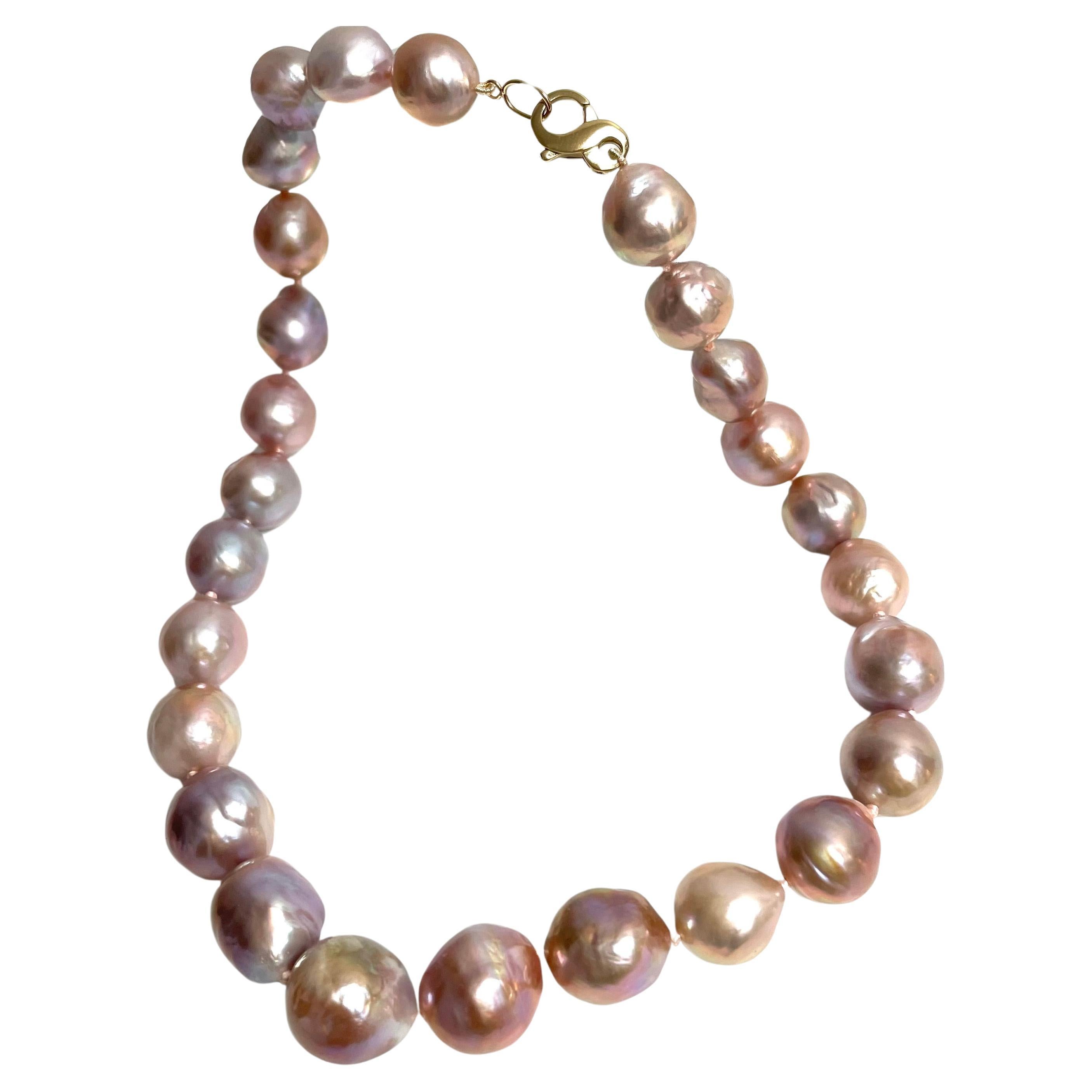 Description
A truly stunning necklace showcasing large 13 to 15 mm semi-baroque freshwater pearls in a unique harmonized variation of natural pink hues, with an unparalleled luster that adds to its timeless beauty.
Item # N3768
For a complete look,