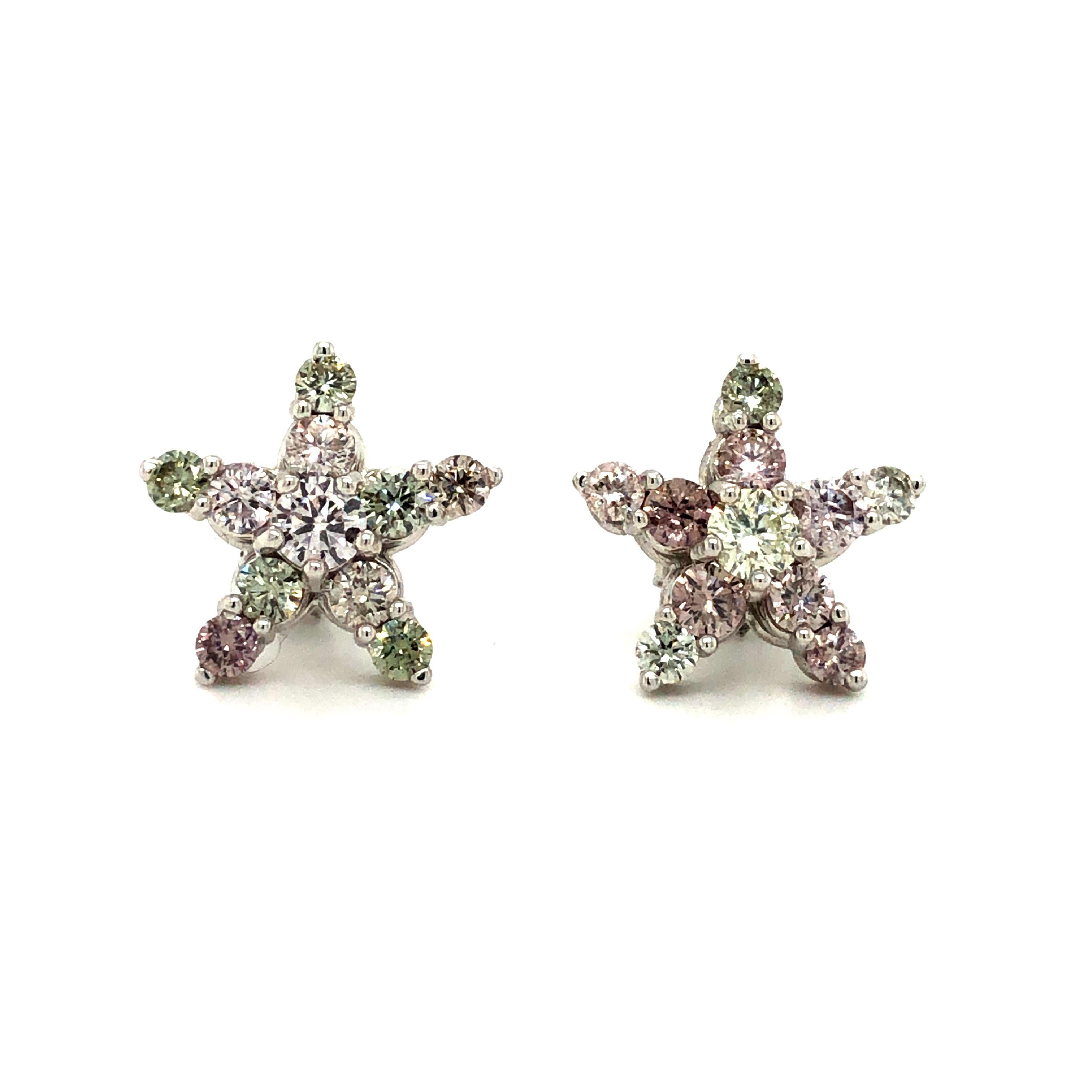 Offered here is a one of a kind star earring, made in solid 18 kt white gold and prong set with 22 natural earth mined pink, green and white diamonds weighing 2.10 carats in the pair, with G.I.A certificate.
Earring has a comfortable and secure push