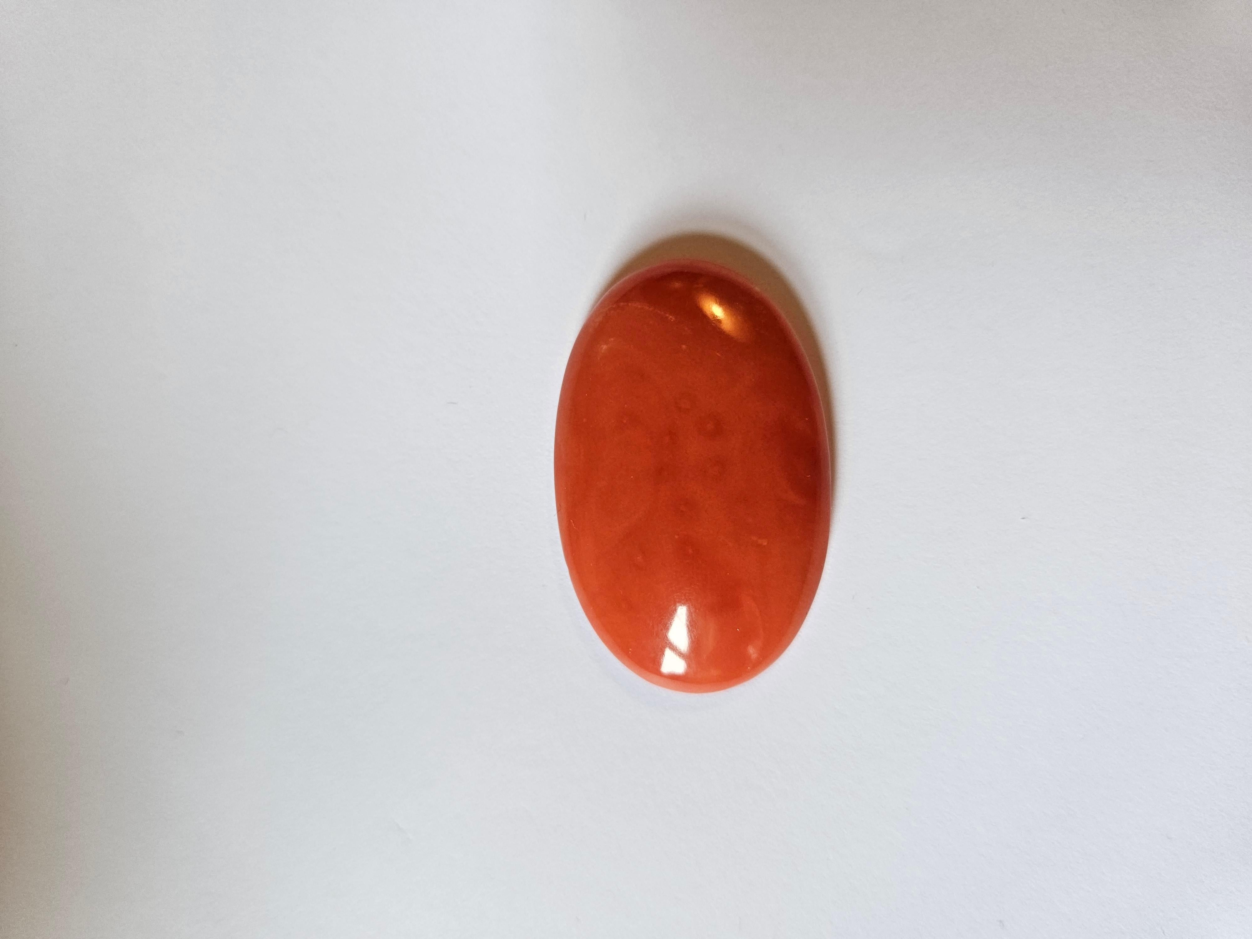 Introducing an exquisite gemstone that will leave you in awe! This gorgeous coral boasts a vivid pink orange color with a stunning oval shape, weighing 50.65 carats and comes with certification. The natural creation of this gemstone makes it even