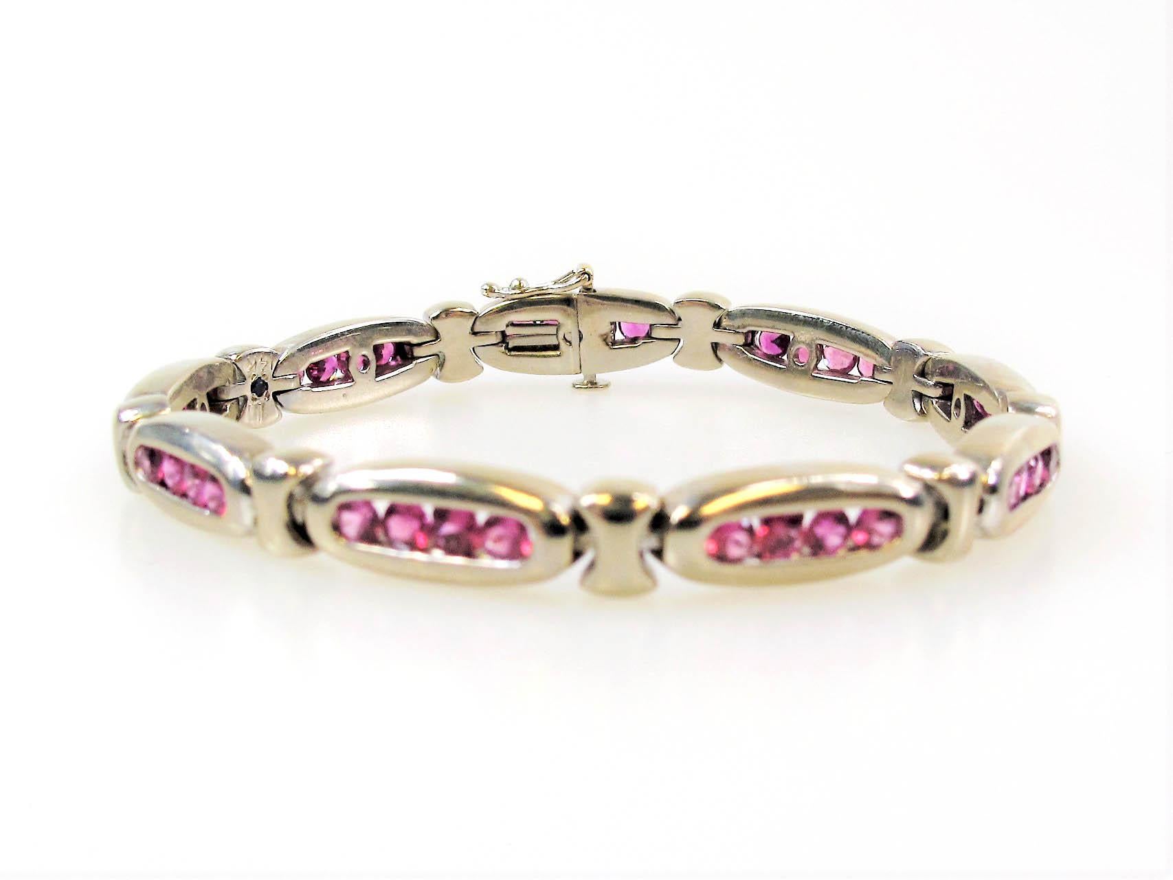 You'll be feeling pretty in pink wearing this incredible 5.00 carat ruby link bracelet! The unique magenta colored ruby stones really pop against the cool white gold in this modern elegant piece. 

This beautiful bracelet features an impressive 5.00