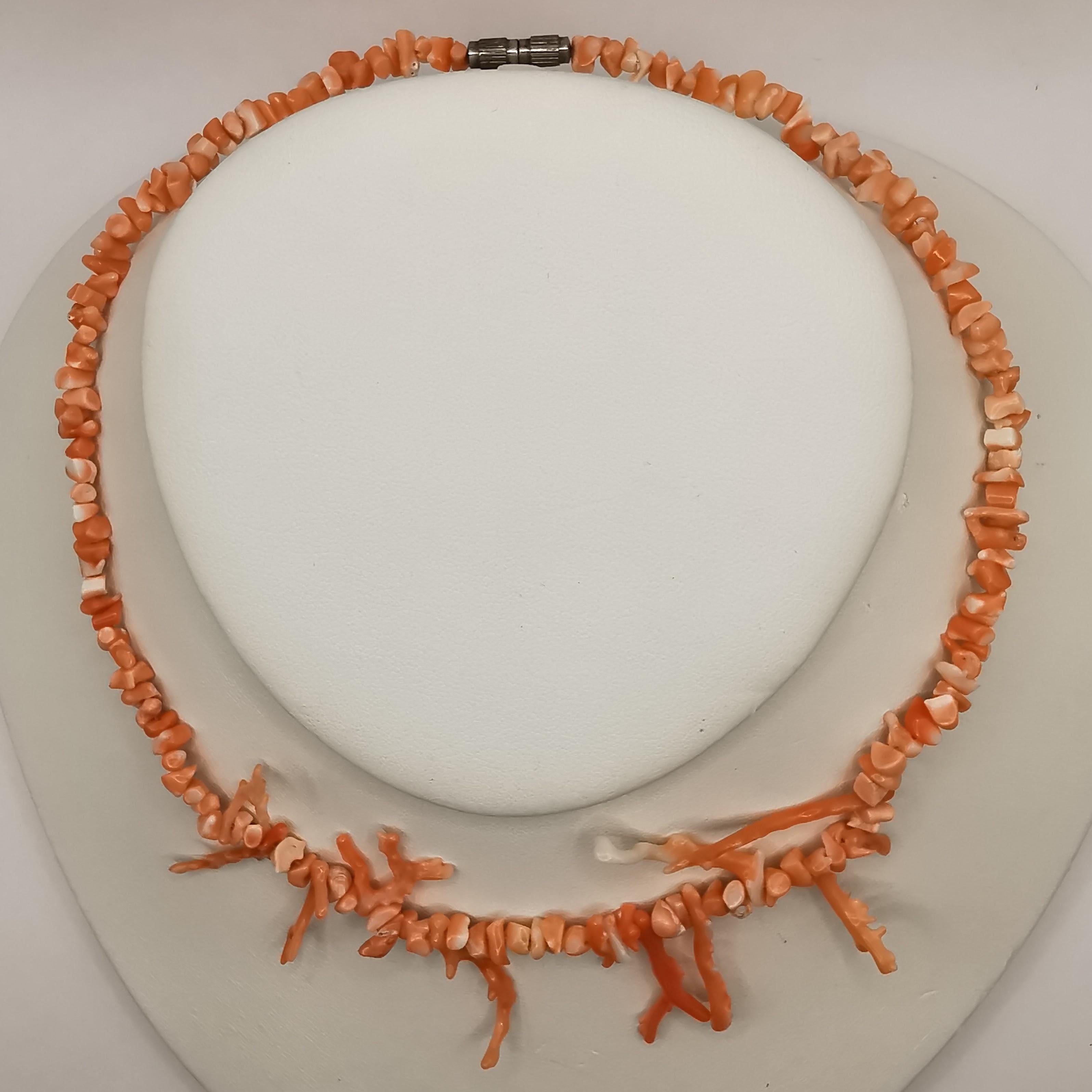 This beautiful natural pink salmon coral necklace is a unique and eye-catching piece that is sure to make a statement. The necklace features a strand of elegant coral beads, each with a unique and organic shape that adds to the necklace's charm. The