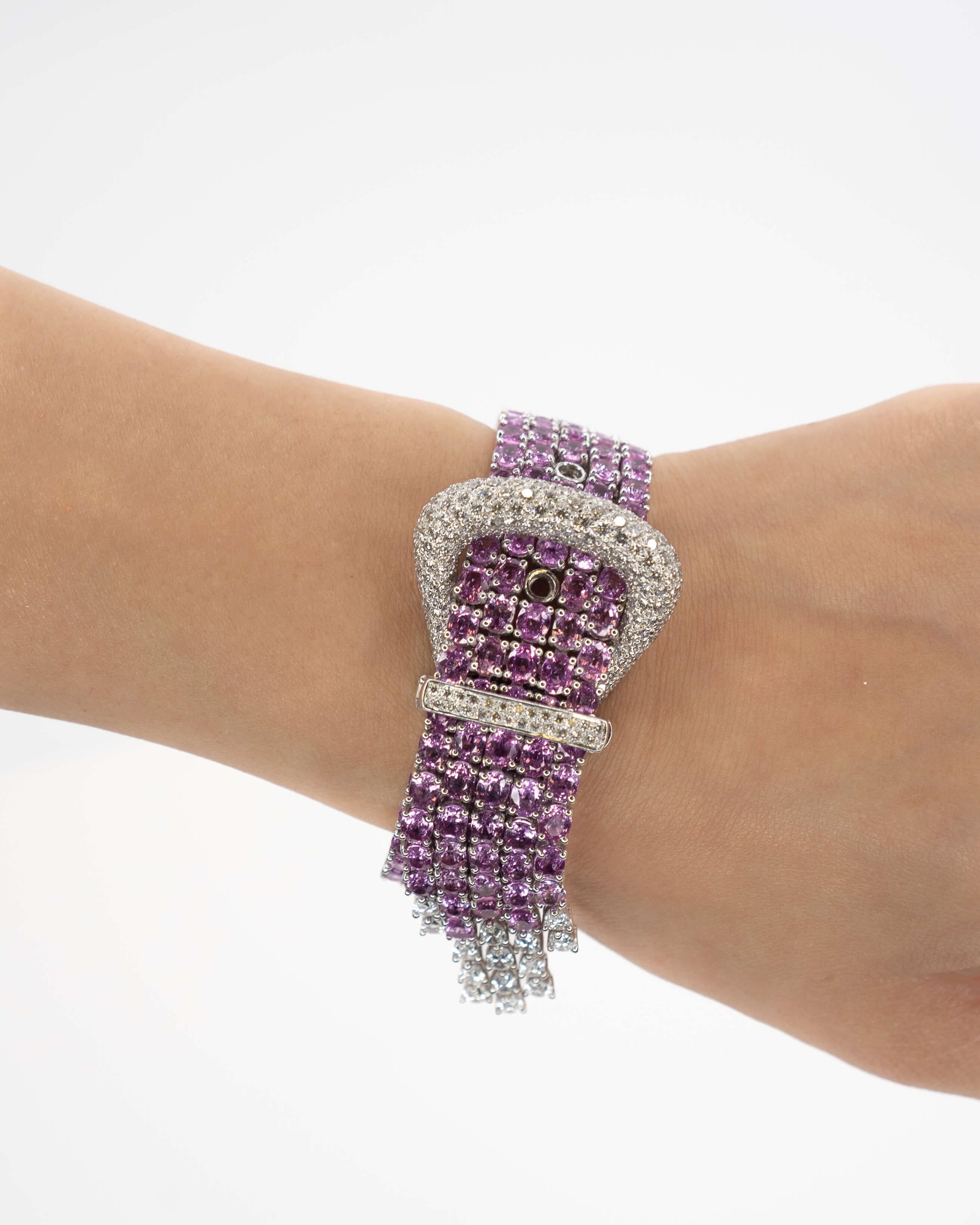 A one of a kind jewelry piece that is like no other. This buckle bracelet sits perfectly on the arm and is filled with rich vibrant color and brilliant diamonds that dance so perfectly! 

18K gold, diamond and pink sapphire bracelet mounted with
