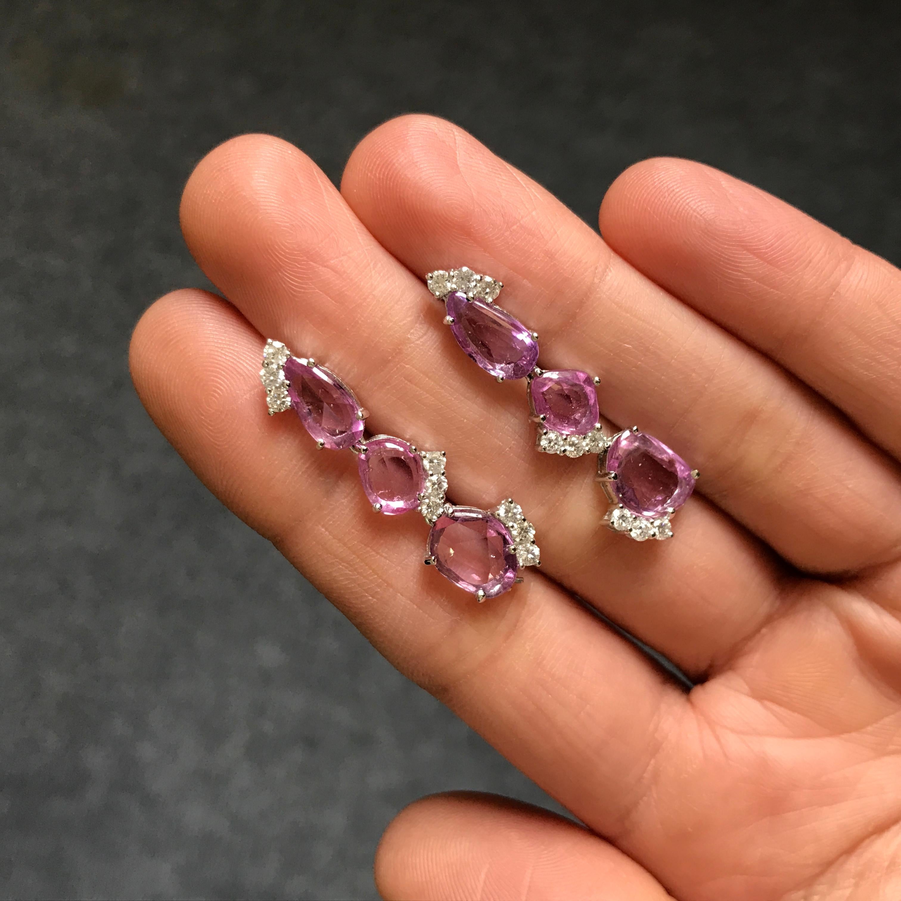 A pair of classy natural Pink Sapphire earrings, adorned with White Diamonds. A total of 15 carats of rose cut Pink Sapphires are used, with 0.2 carats of Diamonds all set in 18K White Gold. 