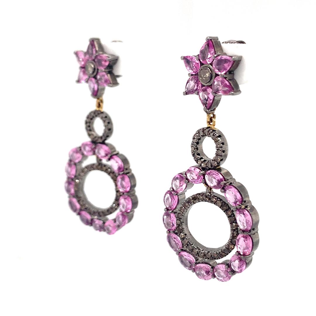 A beautiful pair of Natural 9.50-carat pink sapphire and 1.10-carat diamond earrings set in silver. 