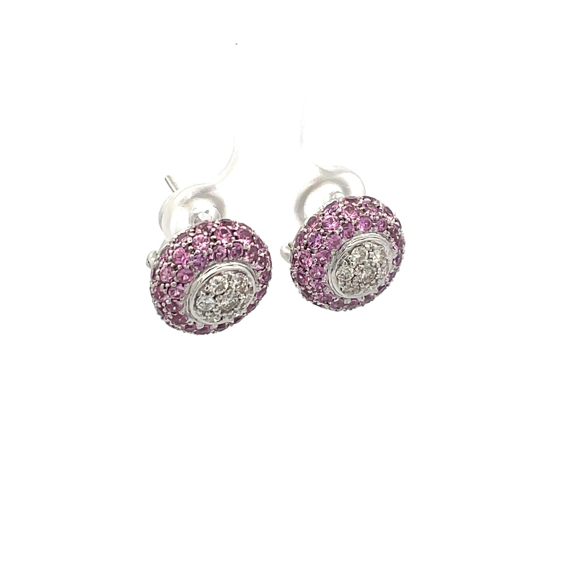 A pair of puff earring set with natural pink sapphires and brilliant cut diamonds in 18kt white gold with a straight post and omega clip system. 

96 natural pink sapphires 4.24ct total weight
14 brilliant cut diamonds 0.60ct total weight, quality