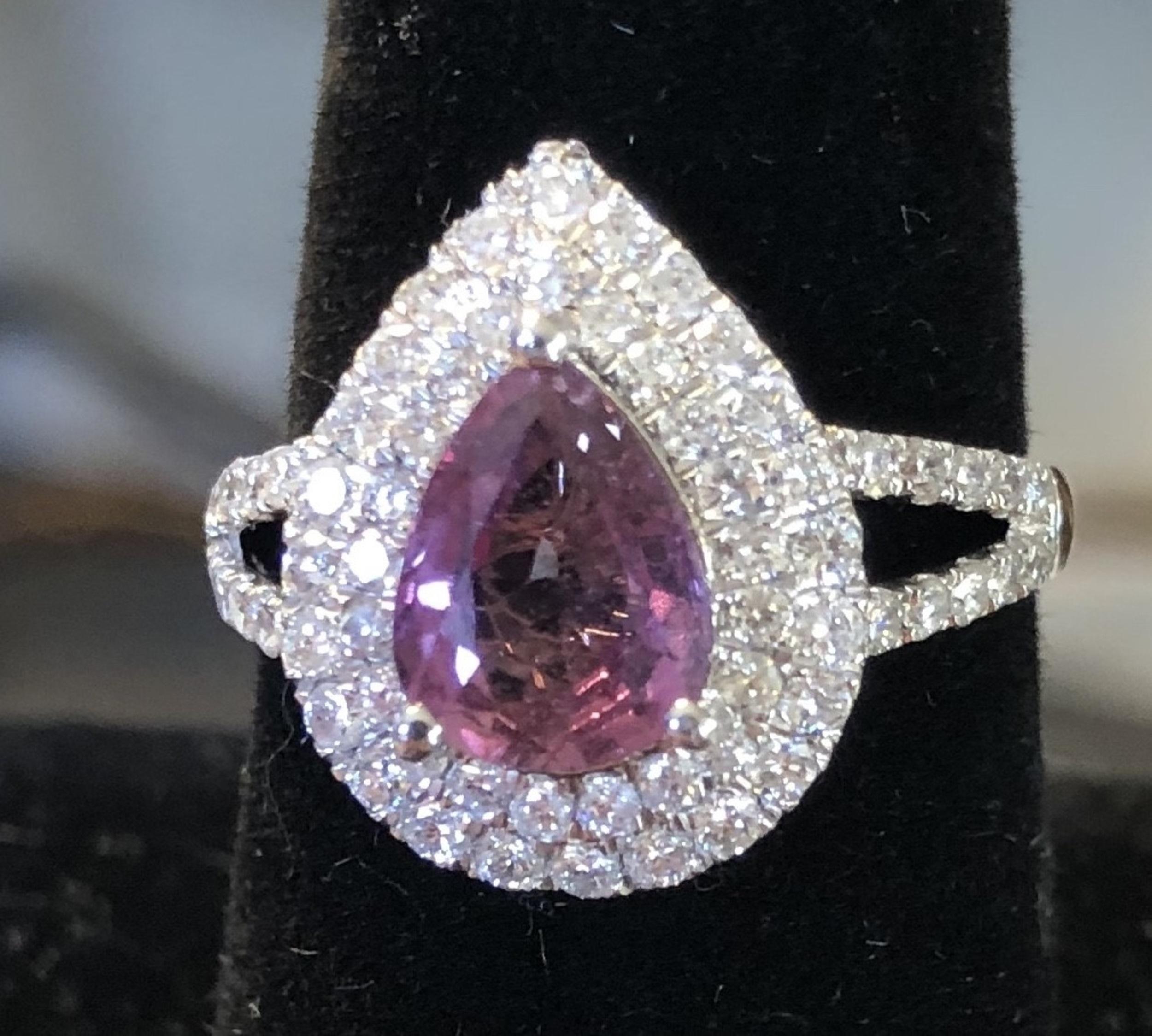 Natural Pink Sapphire and Diamond Ring
Prong-set with a pear shaped pink sapphire weighing 1.98 carats, within a surround of brilliant-cut diamonds weighing approximately .83 carats
set in Platinum, 
5.76 grams (gross), size 7 1/2