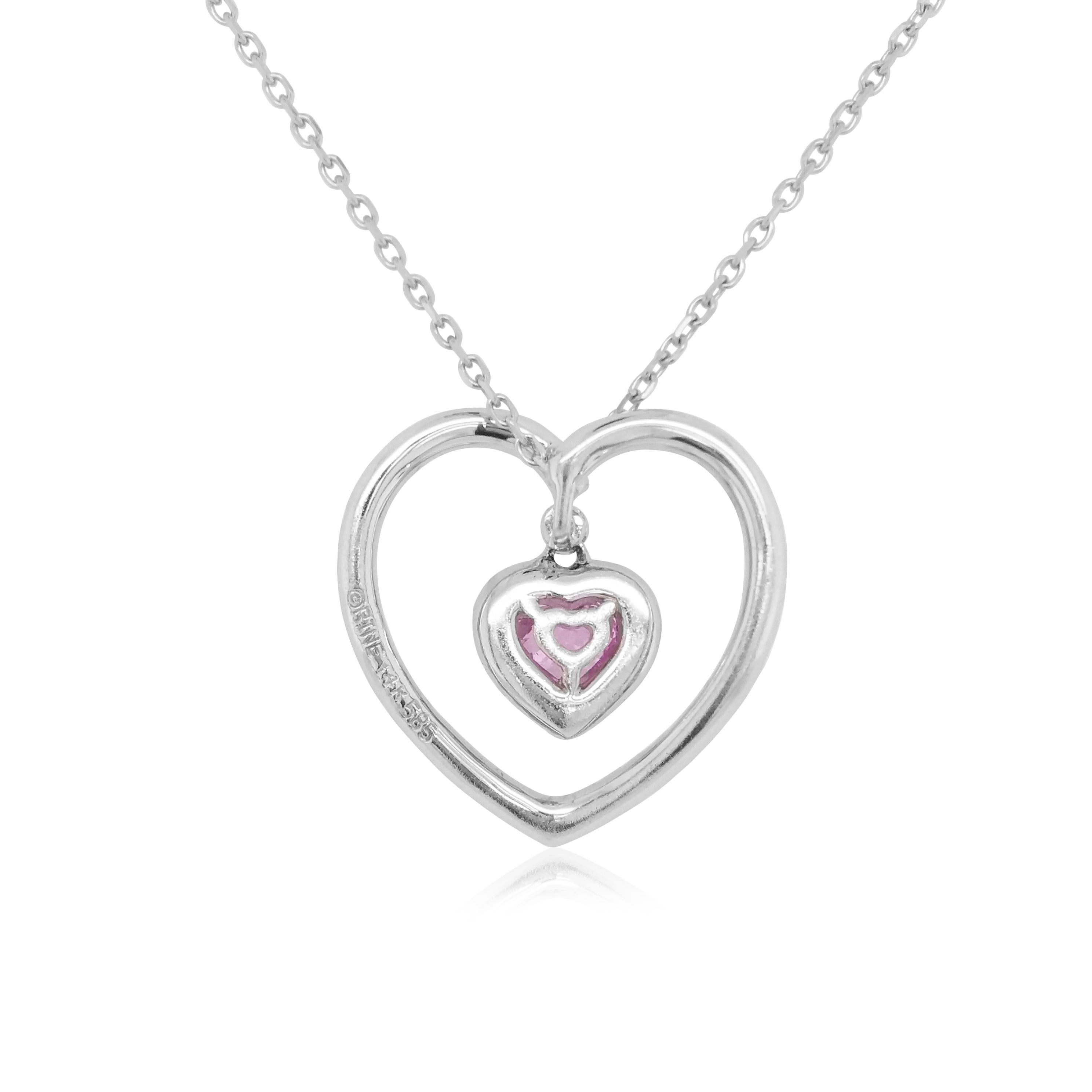 This sweet pendant features a lustrous heart-shaped pink sapphire in a diamond heart-motif. Set in 14 Karat white gold to enhance the lustre of the sapphire and the sparkle of the diamonds. This beautiful pendant would make a romantic and heartfelt