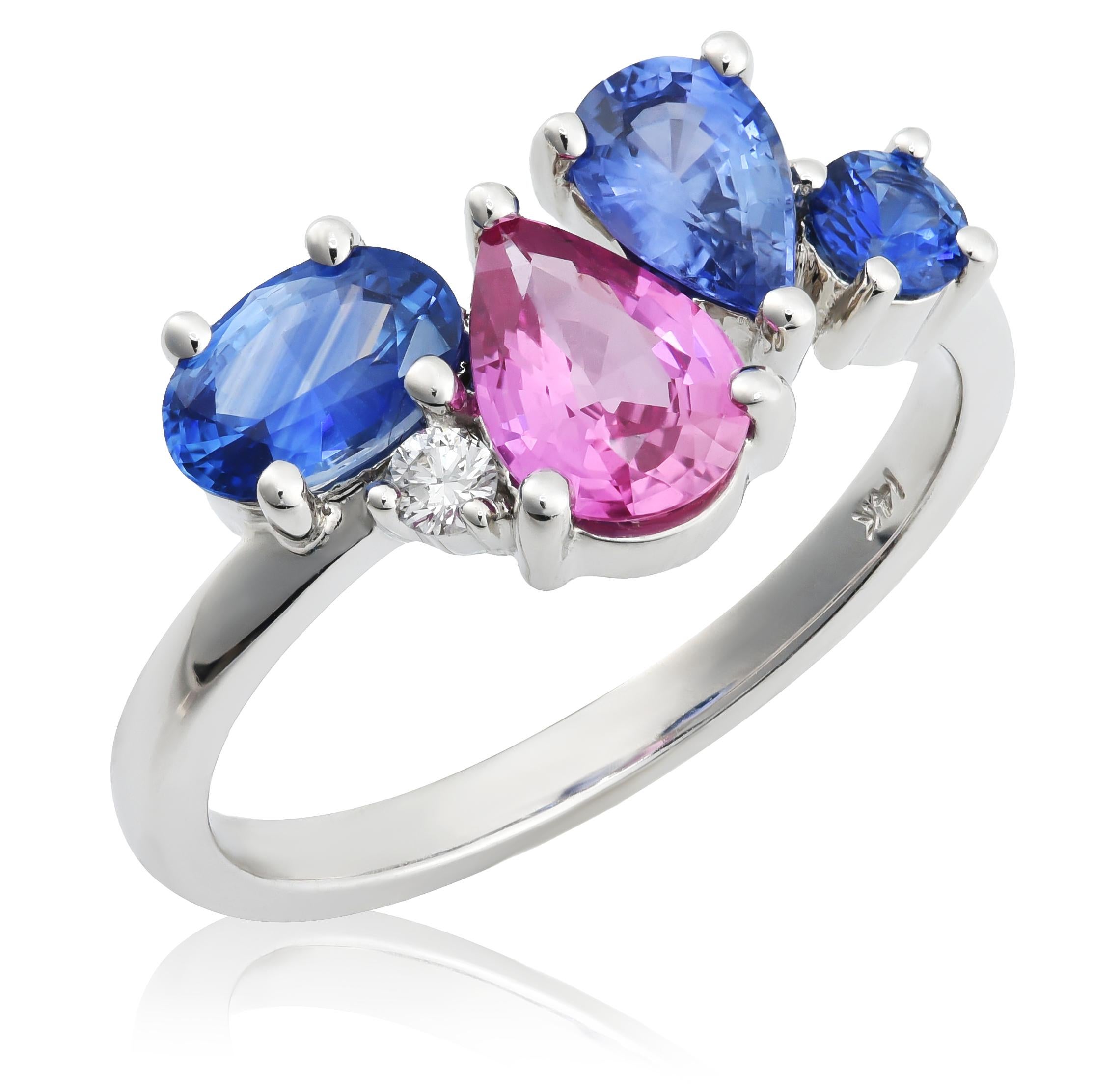 Wir präsentieren einen exquisiten Ring aus 14 Karat Weißgold mit einer faszinierenden Kombination aus rosa und blauen Saphiren, die von einem funkelnden Diamanten akzentuiert werden. Dieses atemberaubende Schmuckstück mit einem Gesamtgewicht von