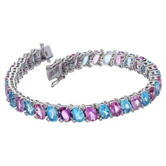 Bracciale tennis con zaffiro rosa naturale, topazio blu e diamanti in oro 18 carati