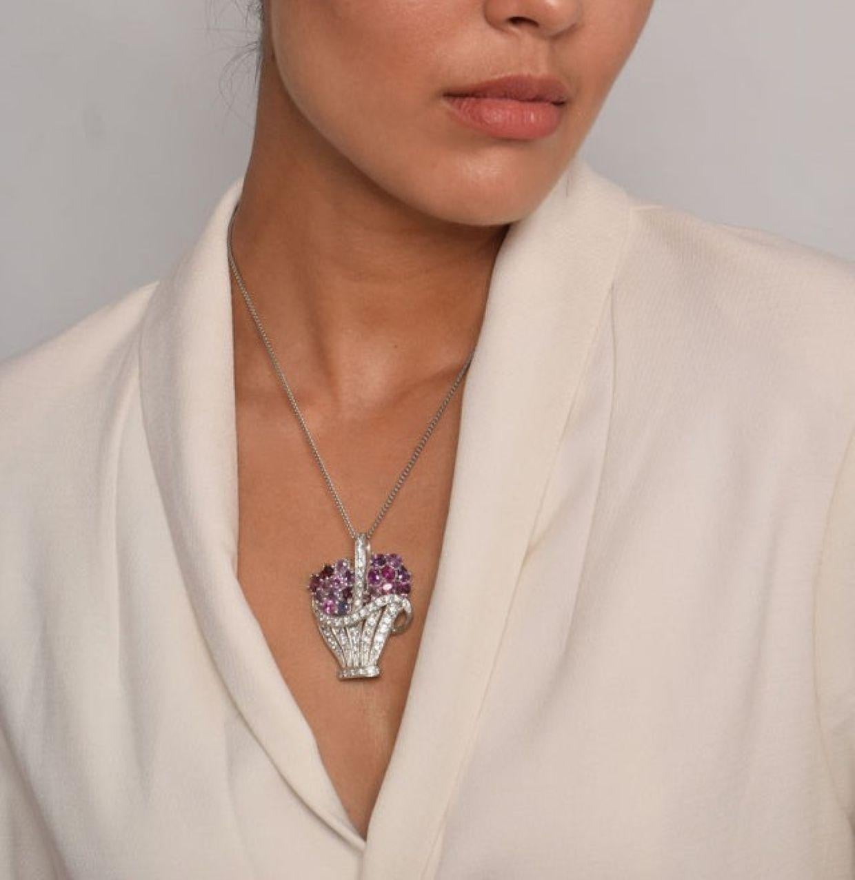 Introducing our exquisite 100% Natural Pink Sapphire Brooch Pendant, a masterpiece of craftsmanship and elegance. Designed to resemble a delicate flower vase, this pendant is adorned with a vibrant bouquet of 20 oval-shaped natural origin pink