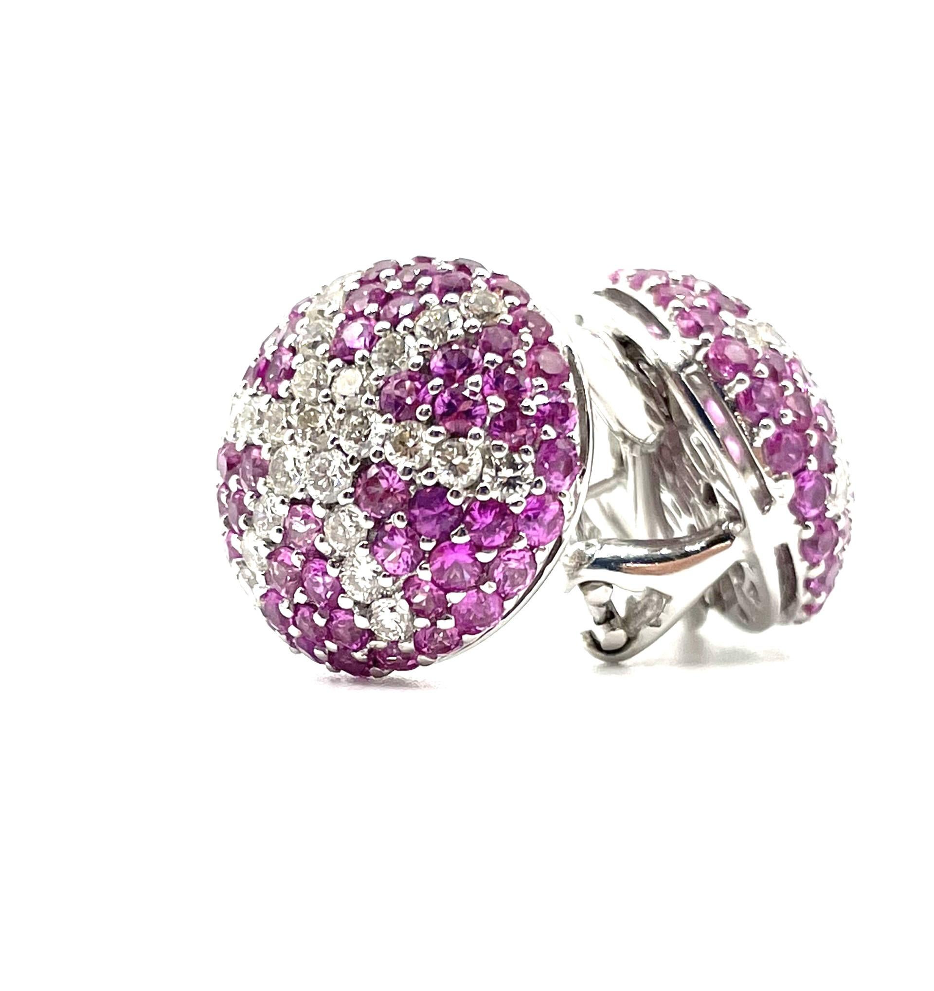 A pair of 18kt white gold round starfish puff  earrings set with natural pink sapphires and white diamonds  with a staright  post and omega clip system.

120 natural pink sapphires 4.85ct total weighty

50 brilliant cut diamonds 1.60 ct total