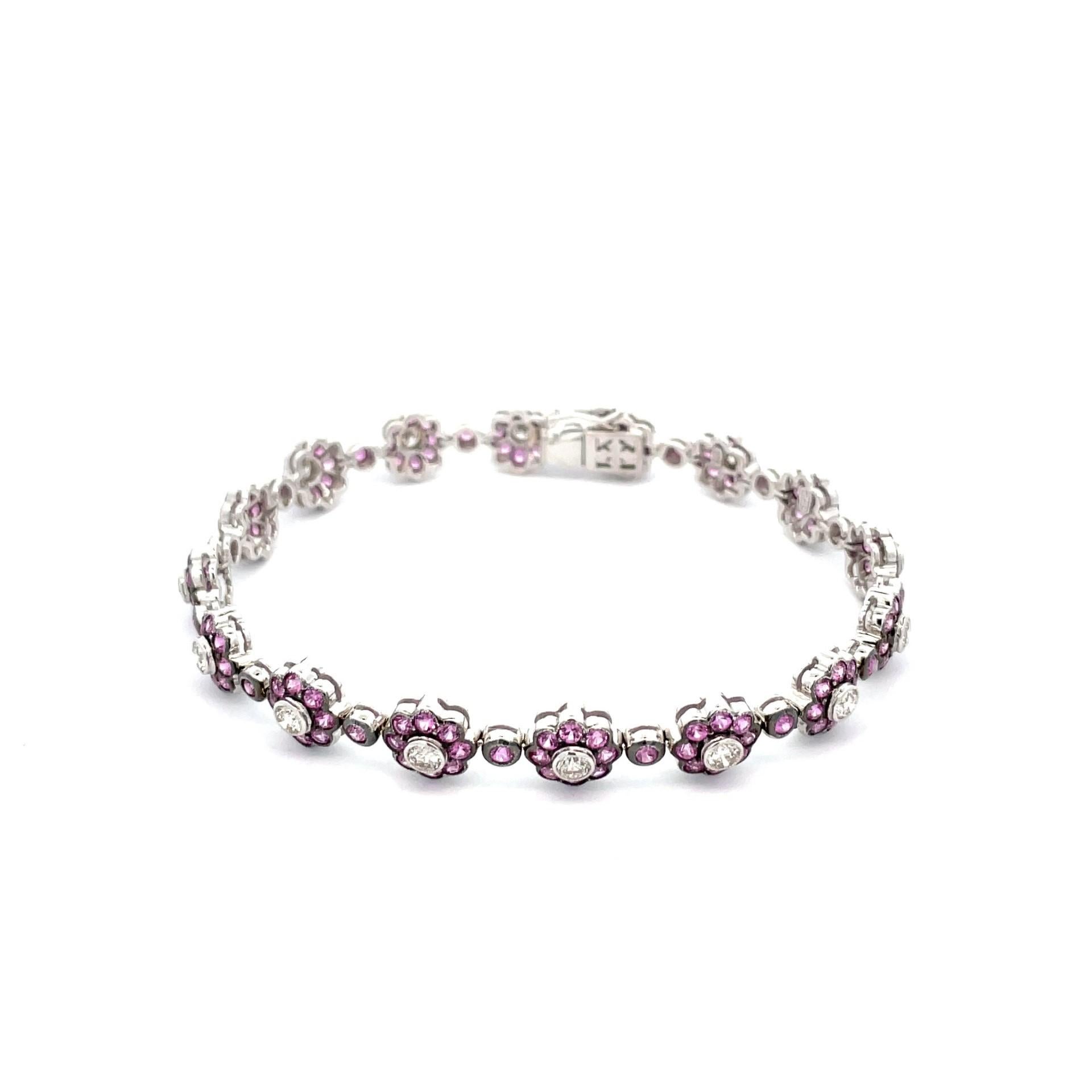 A gorgeous flower bracelet in 18kt white gold with natural pink sapphires and brilliant cut diamonds with a black rhodium finish that highlight the natural pink colour. An elegant casual look for everyday.

144 natural pink sapphires weighing 5.00ct