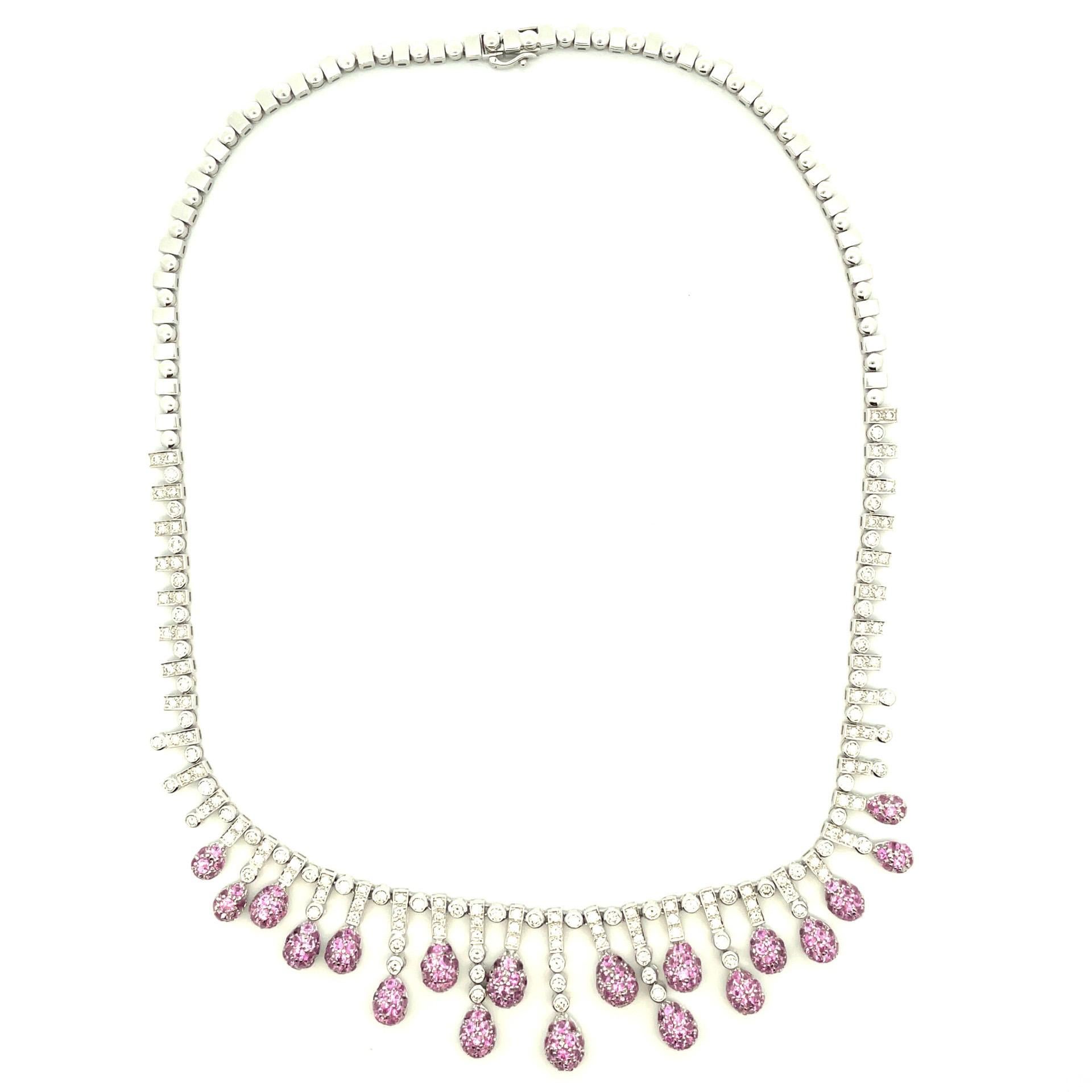 18kt white gold necklace with pink sapphires pave set in teardrops  and set with natural white diamonds. Lays in a beautiful bib style necklace.

156 brilliant cut natural white diamonds 3.73ct total weight

253 natural pink sapphires  6.63ct total