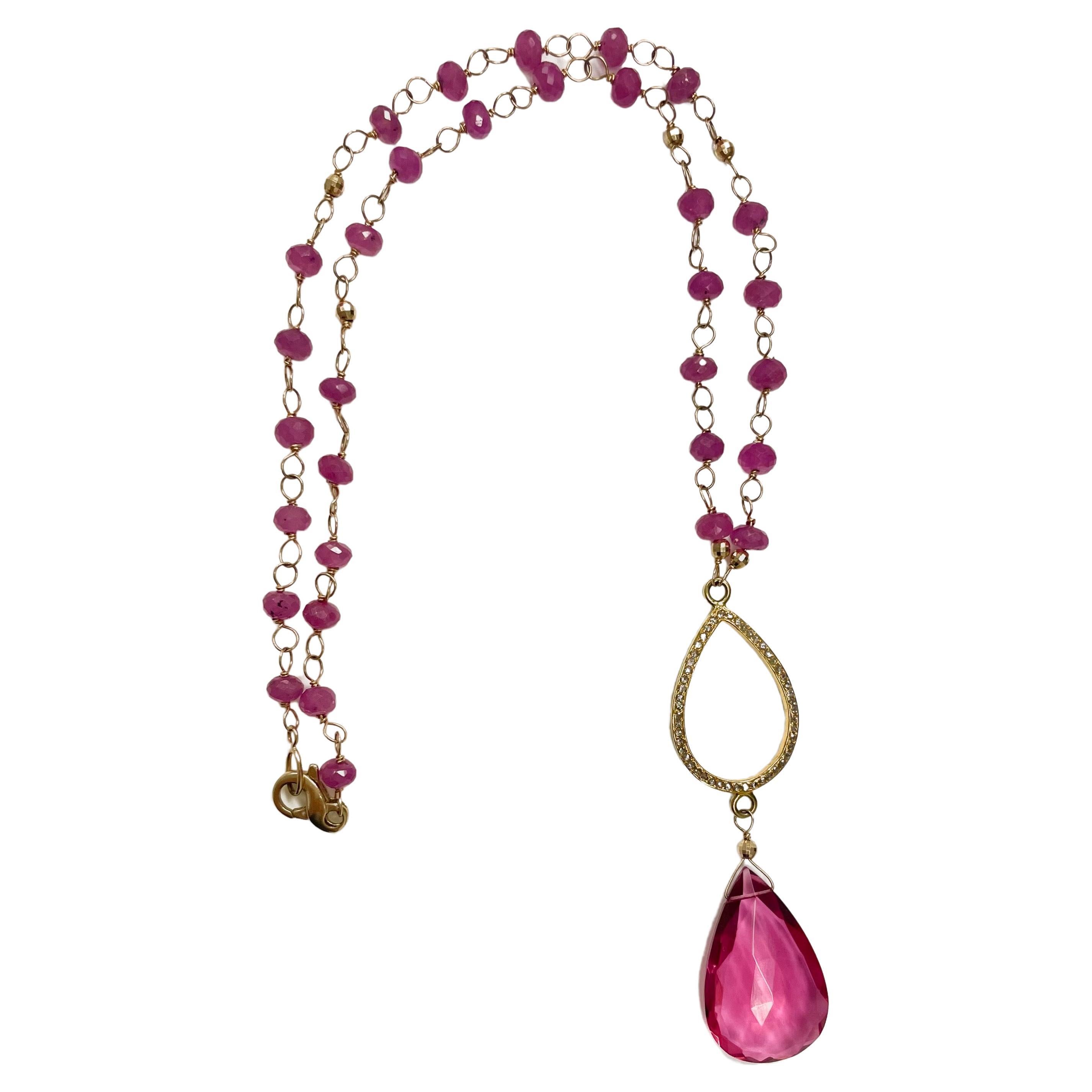 Description
Vibrant pink sapphire, accented with 14k faceted balls and adorned with a large hot pink quartz drop suspended from an 18k yellow gold open pear shape pave diamond piece.  The sapphires are separated with individually handmade links.