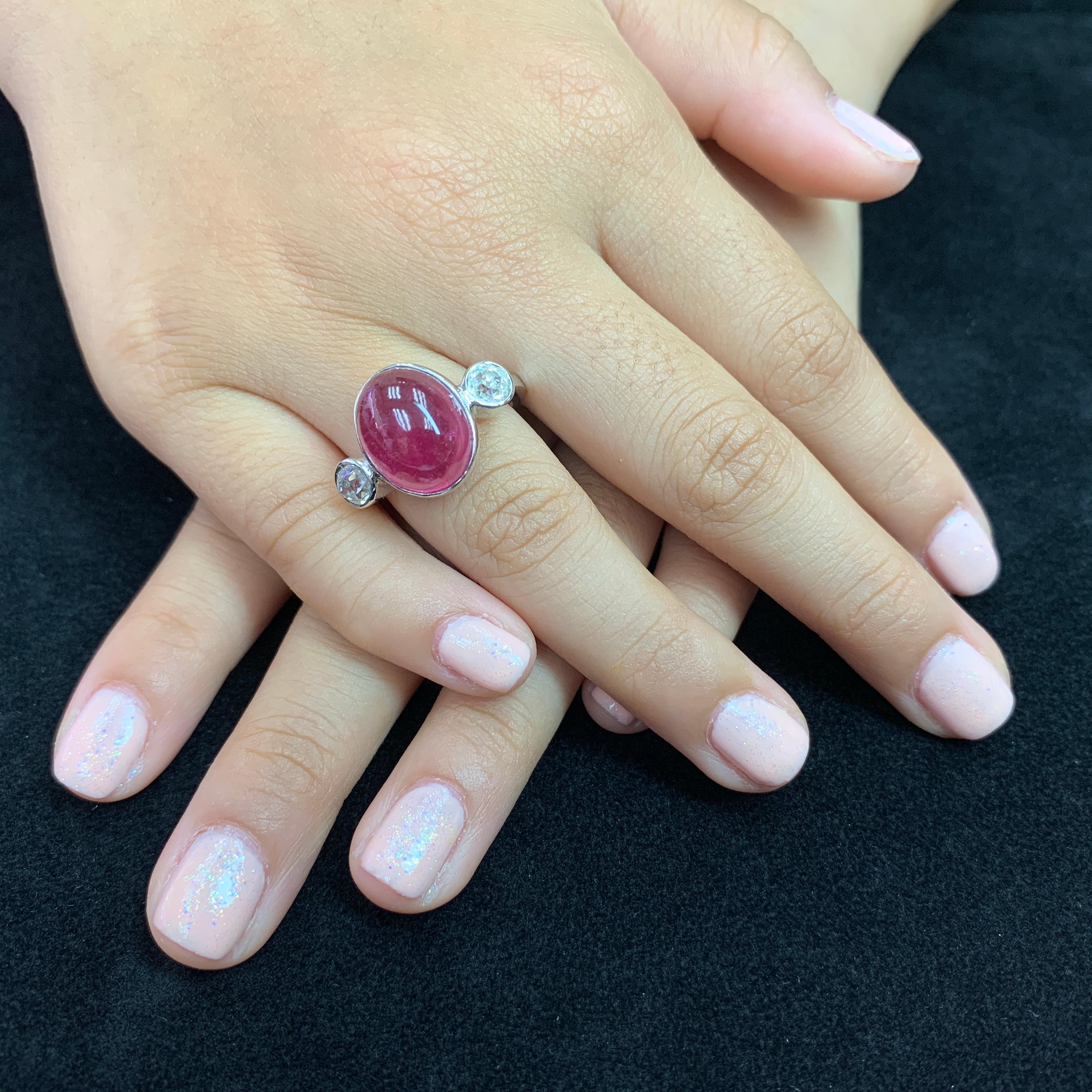 Here is a nice natural pink tourmaline ring with true old mine cut diamonds. This ring will defiantly make a statement. It is impressive! The ring is set in 18k white gold. The center pink tourmaline has a nice high dome and it is 10.16 Cts. On each