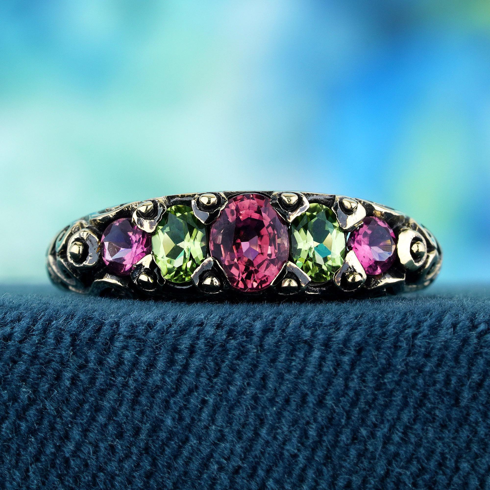 The focal point of this vintage-inspired ring lies in its array of five gemstones. Three captivating pink tourmalines intertwine with lime green peridots, adding a touch of sparkle and grace to the ensemble. Crafted in a yellow gold prong setting,
