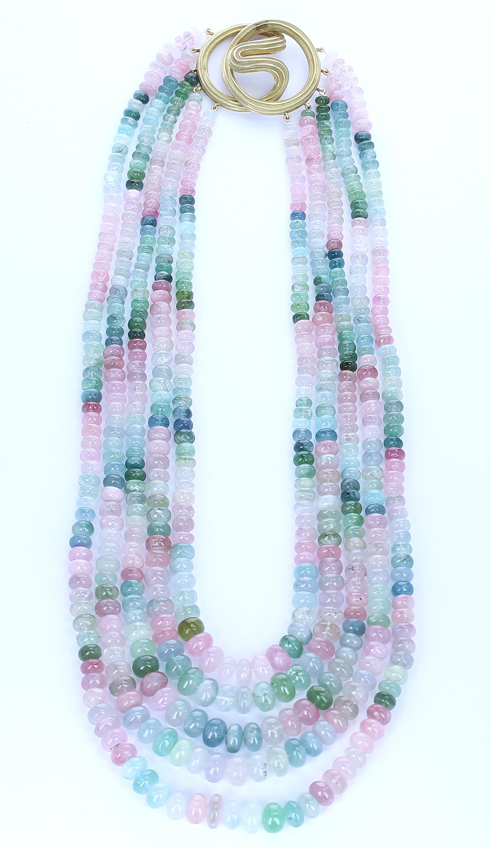 A Natural Plain Multi-Tourmaline Necklace consisting of 5 lines. The beads weigh a total of 1358 carats, the clasp weighs 123 carats, and the total weight of the necklace is 1481 carats. The clasp is in 18 Karat Gold and is by Christopher Walling.