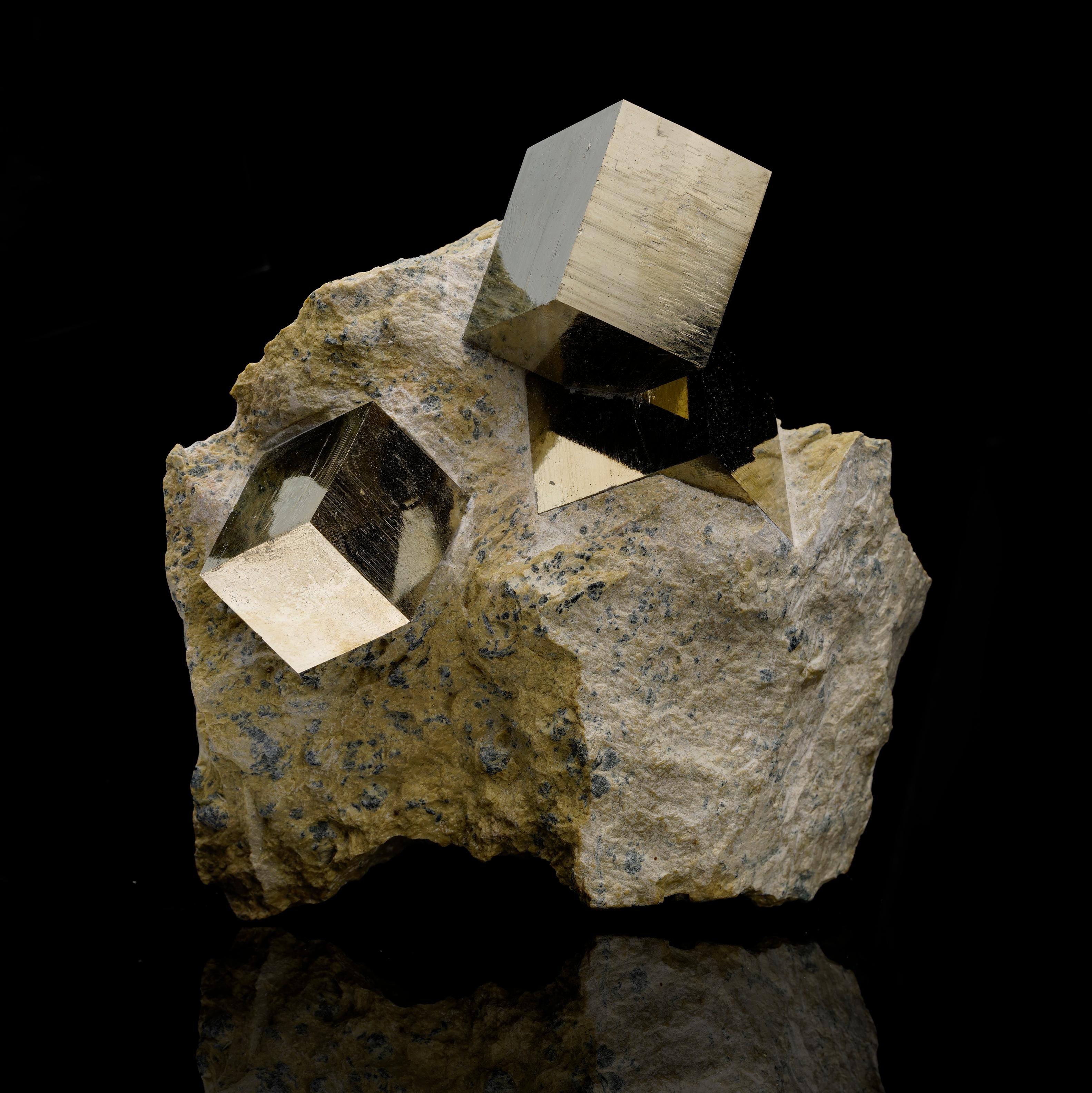 This exceptional Pyrite specimen from Spain showcases multiple large, sharply defined Pyrite cubes perfectly embedded in their natural matrix. The metallic luster and flawless geometric structure of each cube offer a stunning display of nature’s