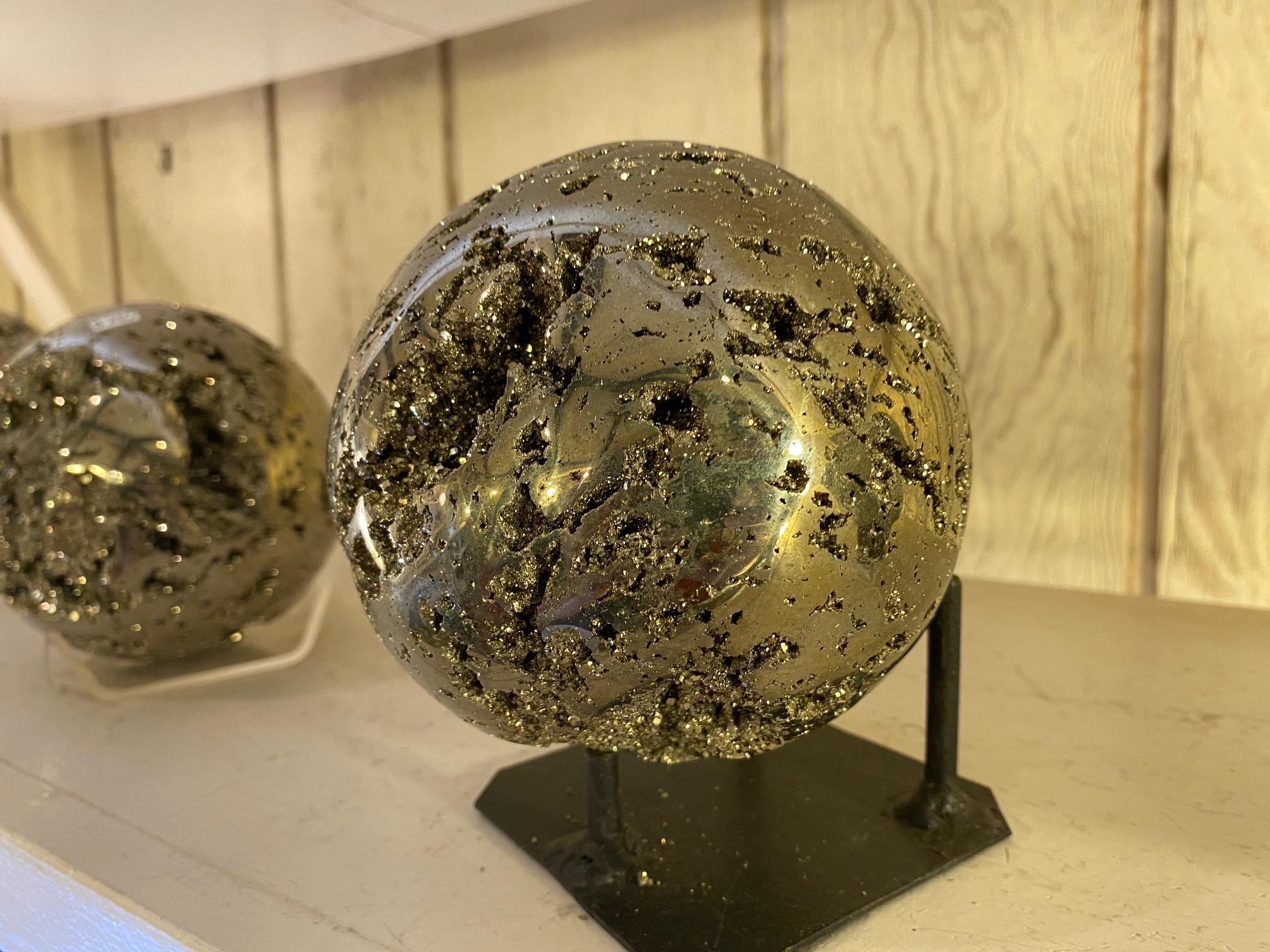 Natural mineral pyrite from Peru, artisan polished into a sphere witch highlighted the beauty of this stone with all the natural craters. Also know as Fools Gold this mineral is know to protect against any negative energy but it also works as a