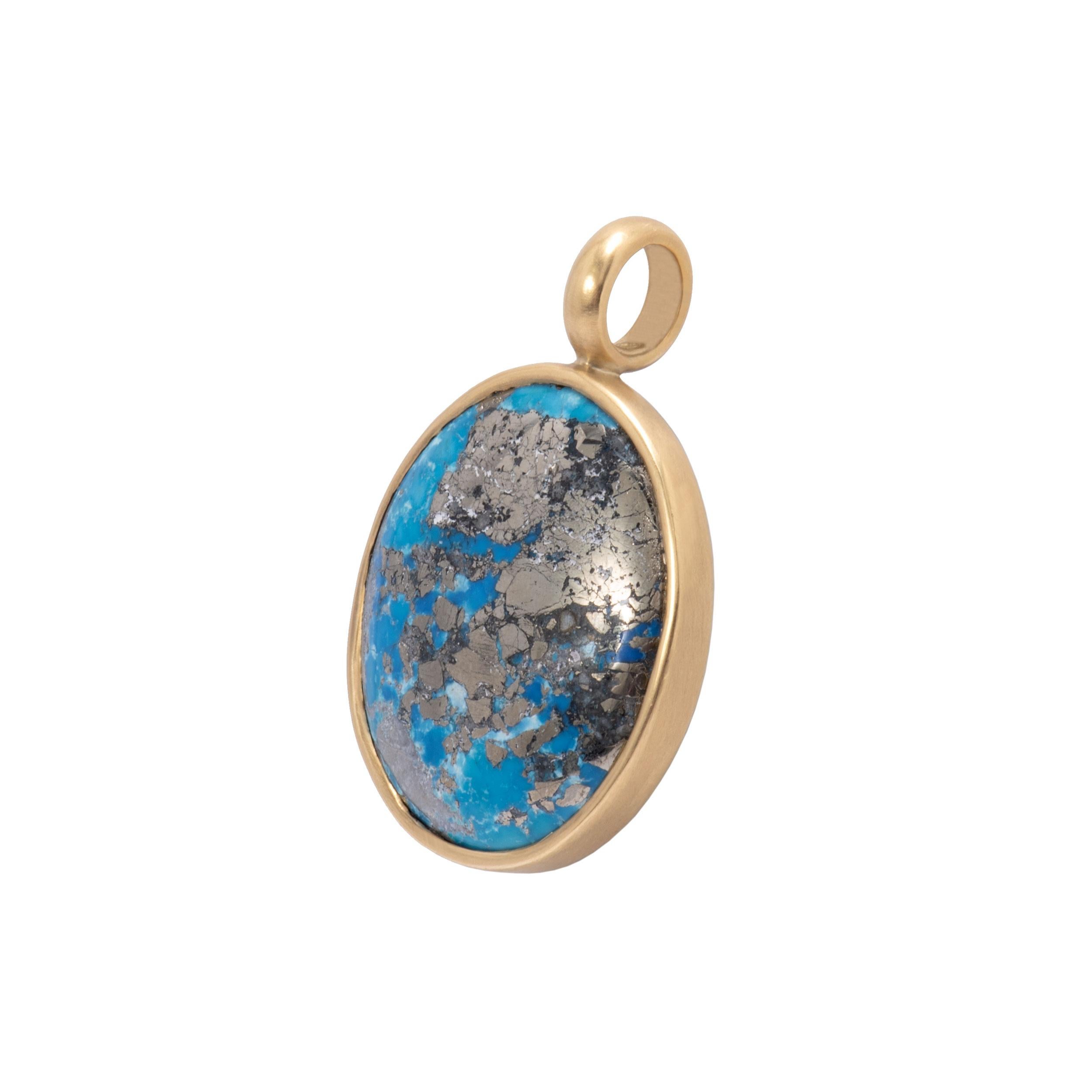 A striking Persian Turquoise Pendant with unusual pyrite matrix in a 72.5ct oval cabochon is bezel set in 18k gold with our signature satin finish. The Natural Pyrited Persian Turquoise Pendant features an atlas of pyrite matrix from the host stone