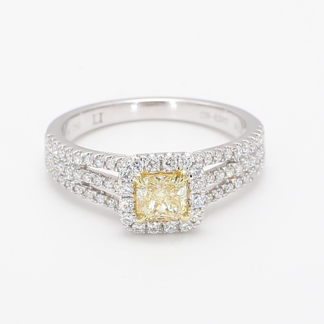 Rare radiant natural yellow diamond surrounded with natural round white diamonds. This ring is designed to be in a simple but intriguing setting with a single array of diamonds surrounding the centerstone as well as diamonds along the beautiful