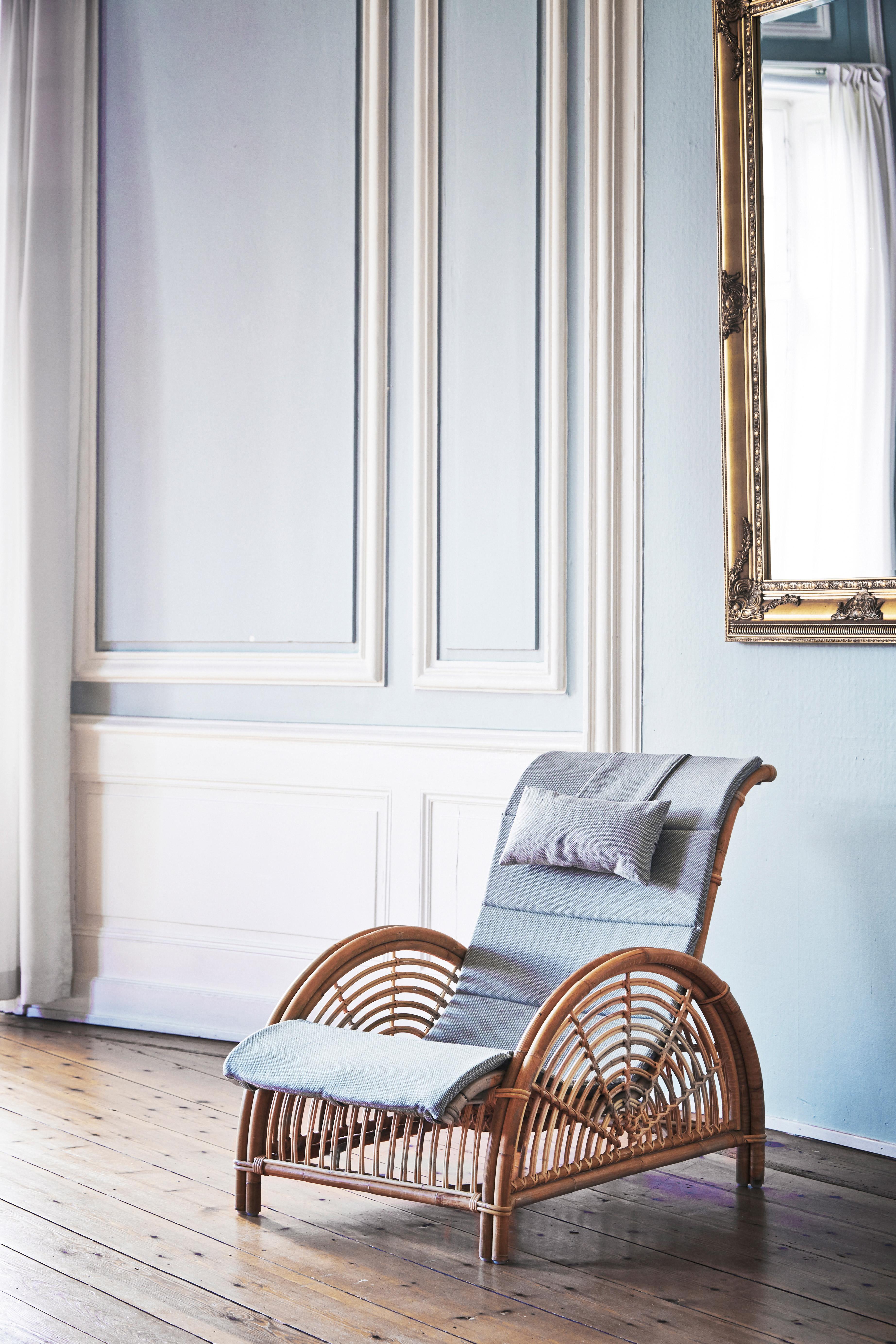 Arne Jacobsen designed the original Paris chair in 1925. This sculptural rattan piece was Jacobsen's first furniture design and won a silver medal at the Paris Art Deco Fair. This chair's striking curvature makes for an elegant and comfortable work