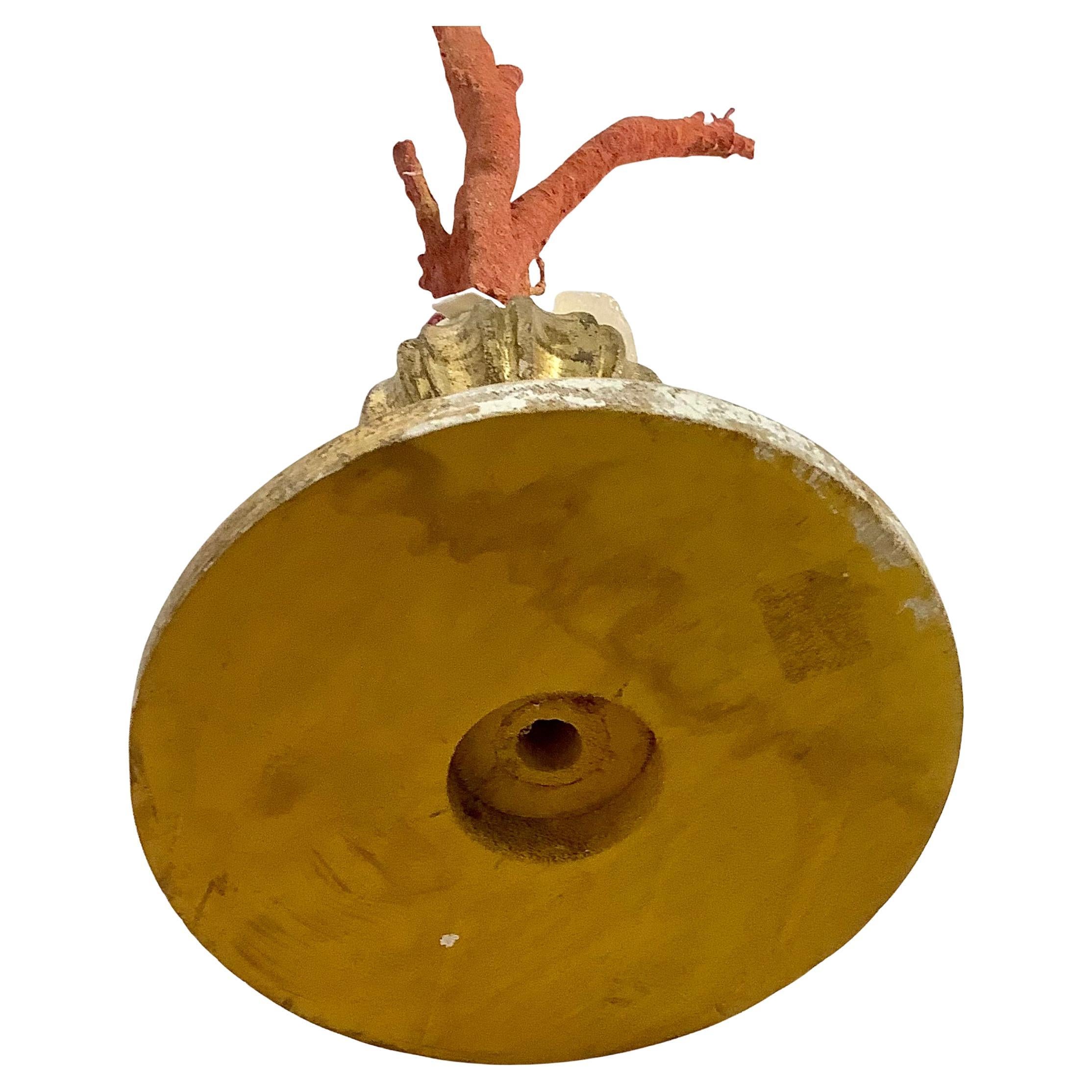 A hand-crafted sculpture specimen of natural red coral branches mounted on a 18th century giltwood urn fragment base.