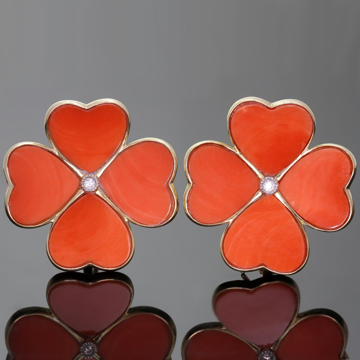 These classic timeless earrings feature a large clover flower design crafted in 18k yellow gold and set with 4 natural red coral petals and a solitaire brilliant-cut round diamond of an estimated 0.10 carats. Completed with lever-backs and