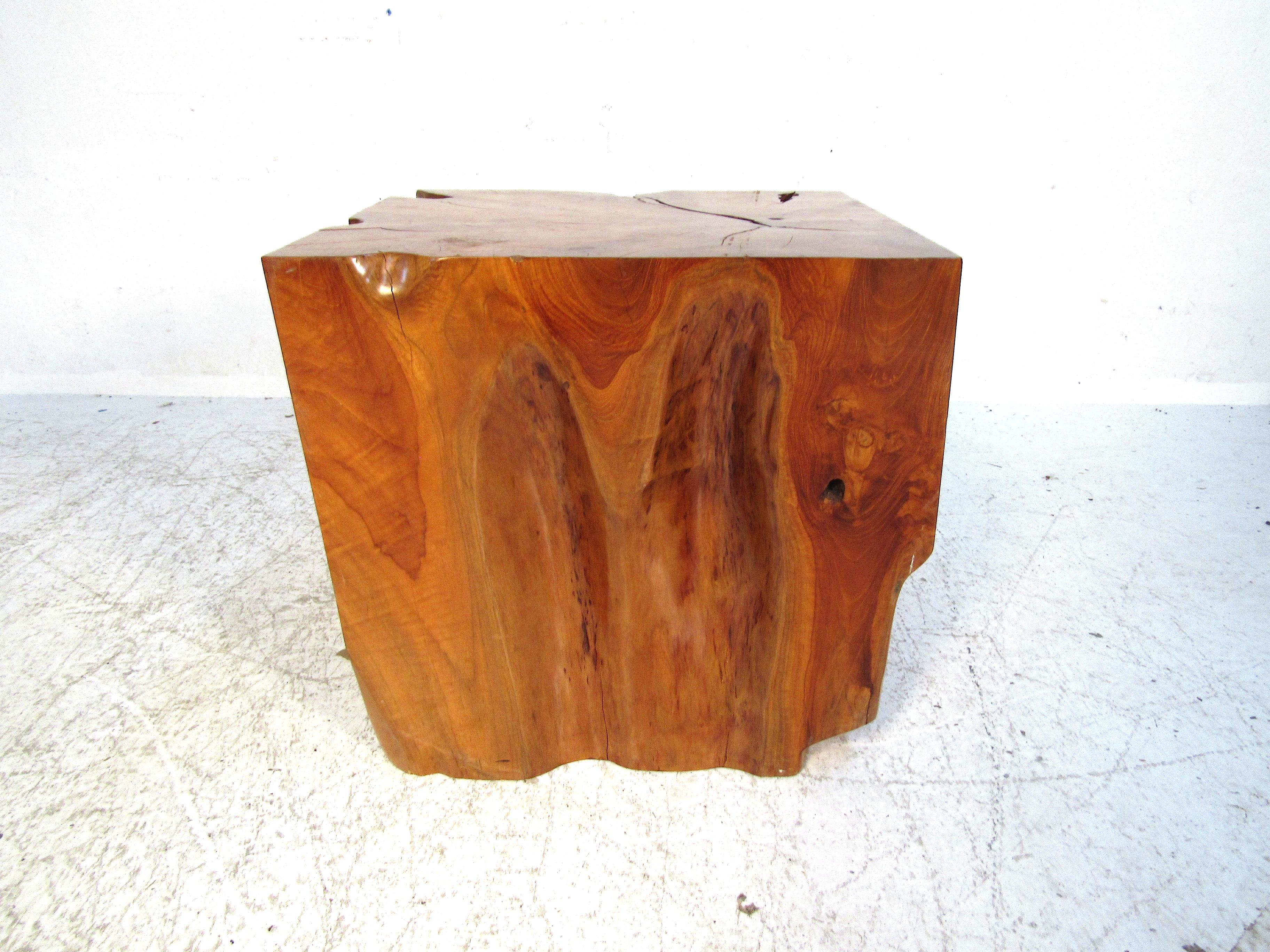 This beautiful one of a kind side table will impress even the harshest of critics. Made of red oak this piece is one solid piece of wood cut from where the tree trunk meets the root system of the tree. This creates stunningly unique and varied grain