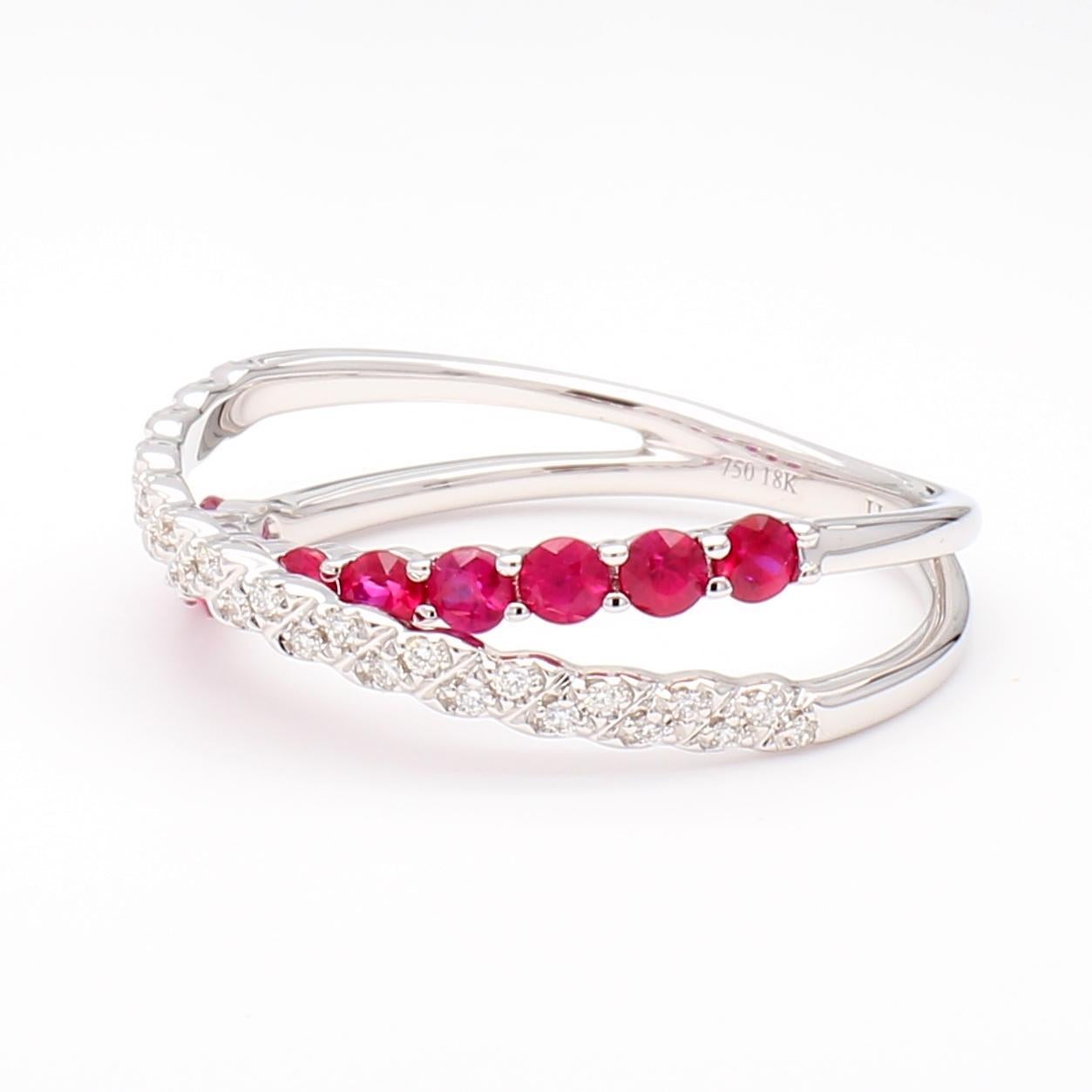 RareGemWorld's beautiful wedding band. Mounted in a beautiful 18K White Gold setting with a natural round cut red ruby's complimented by natural round white diamond melee. This band is guaranteed to impress and enhance your personal