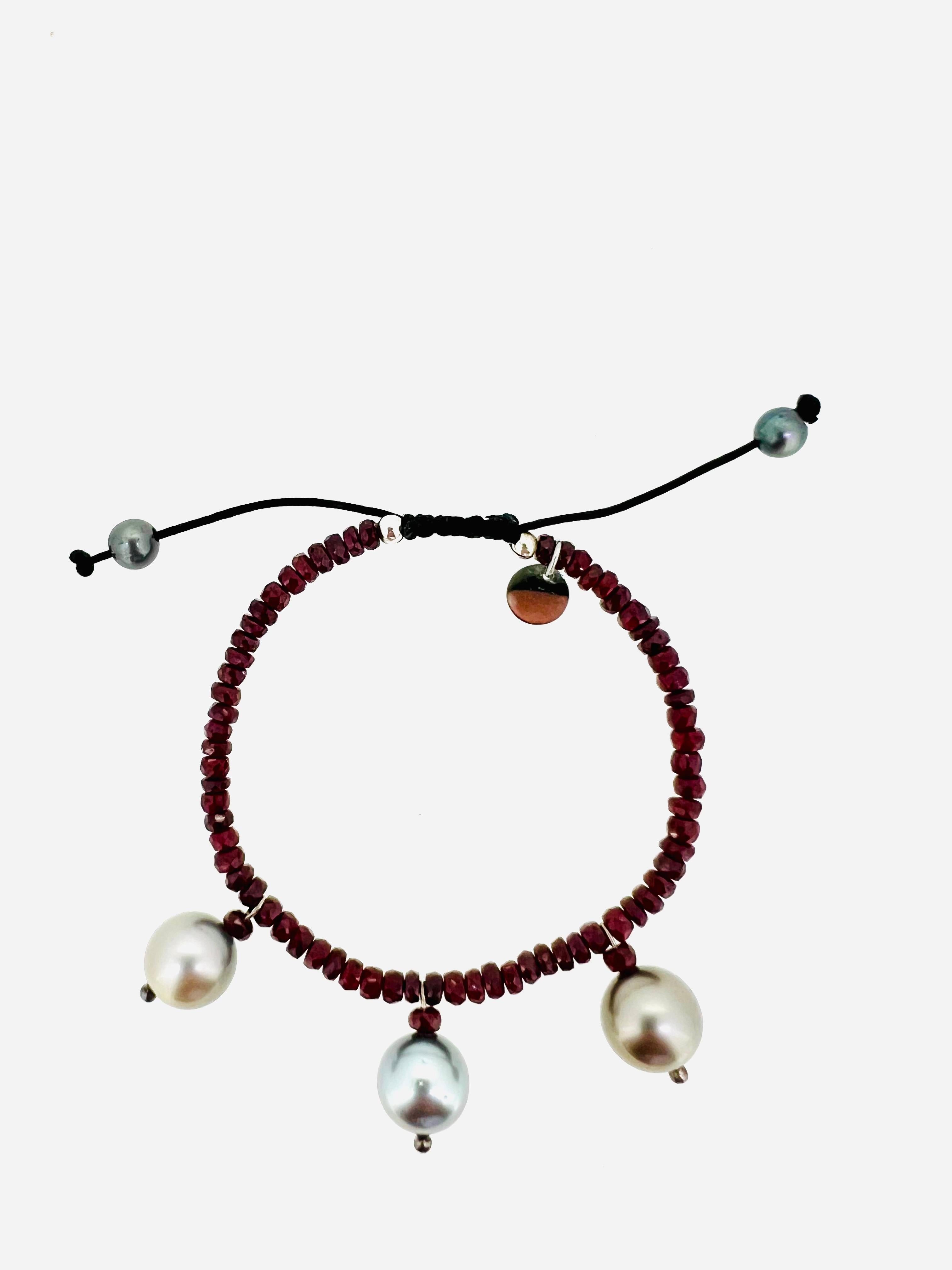 
**About 18 Carat Natural Red Ruby Beads:**
Noble rubies symbolizing love, passion, and life, handcrafted in Germany.

**Signature Tahiti Pearls:**
Exquisite gray Tahitian pearls embodying the power of the sea, adding a luxurious touch to the