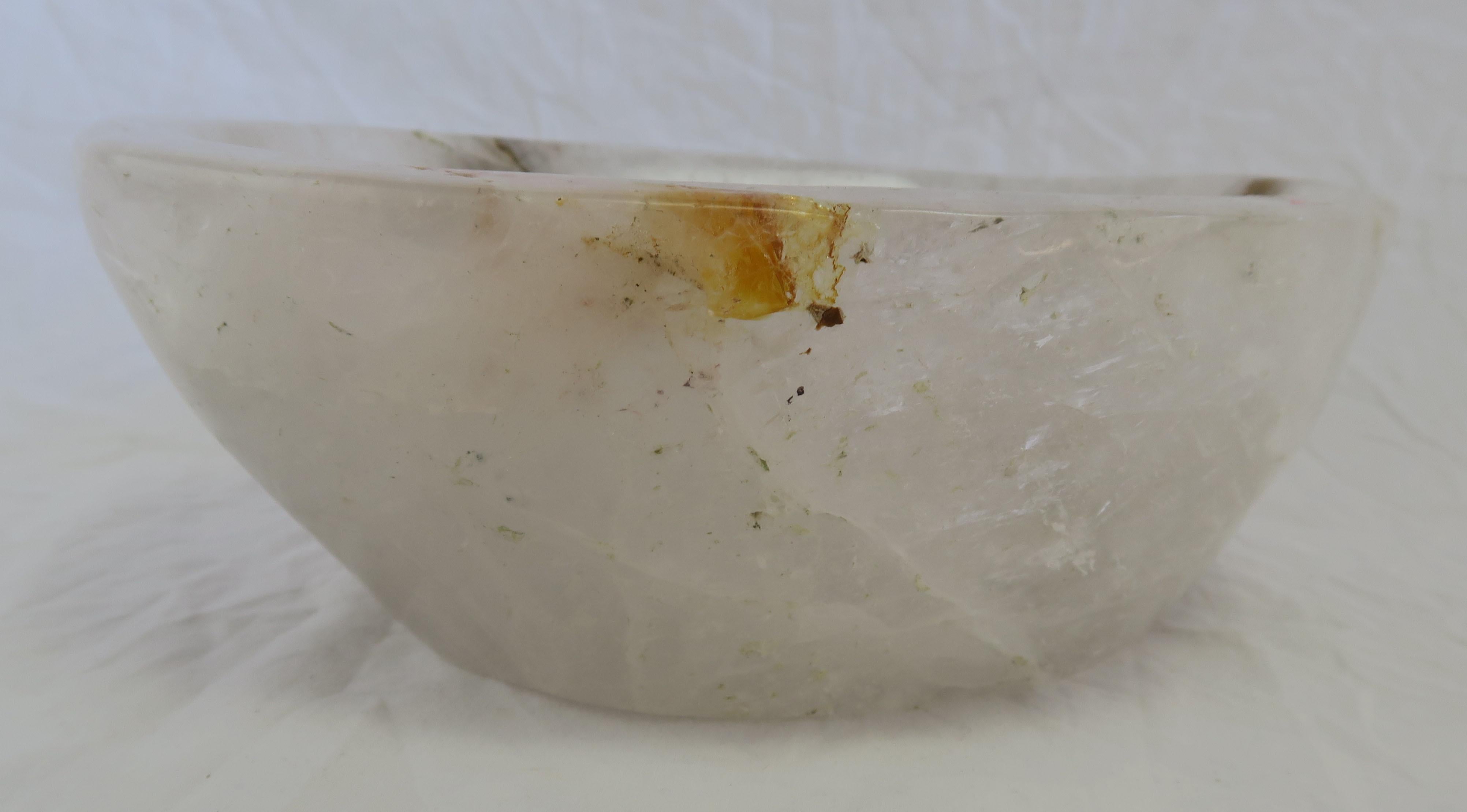 Natural specimen rock crystal bowl in white with a dramatic black accent. Hand-carved from very large chunk keeping in its natural organic shape. Beautiful accent bowl for your table.
 