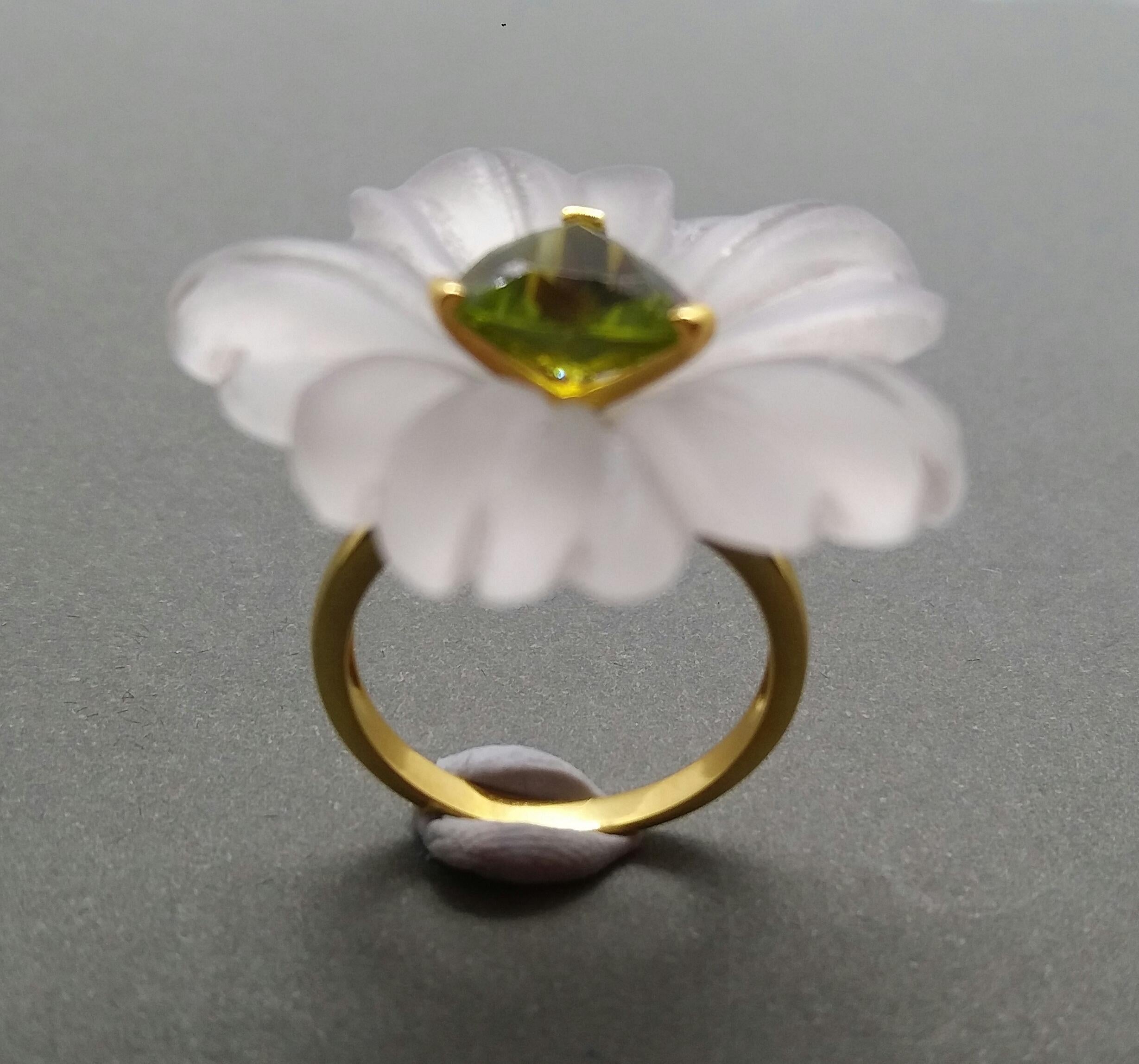 Flower carved Natural Rock Crystal (White Quartz) of 28 mm. in diameter with in the center a Trillion Cut Peridot 10 mm size set in solid 14 Kt yellow gold is mounted on top of a 14 Kt. yellow gold shank. US size # 7 (but resizable according to