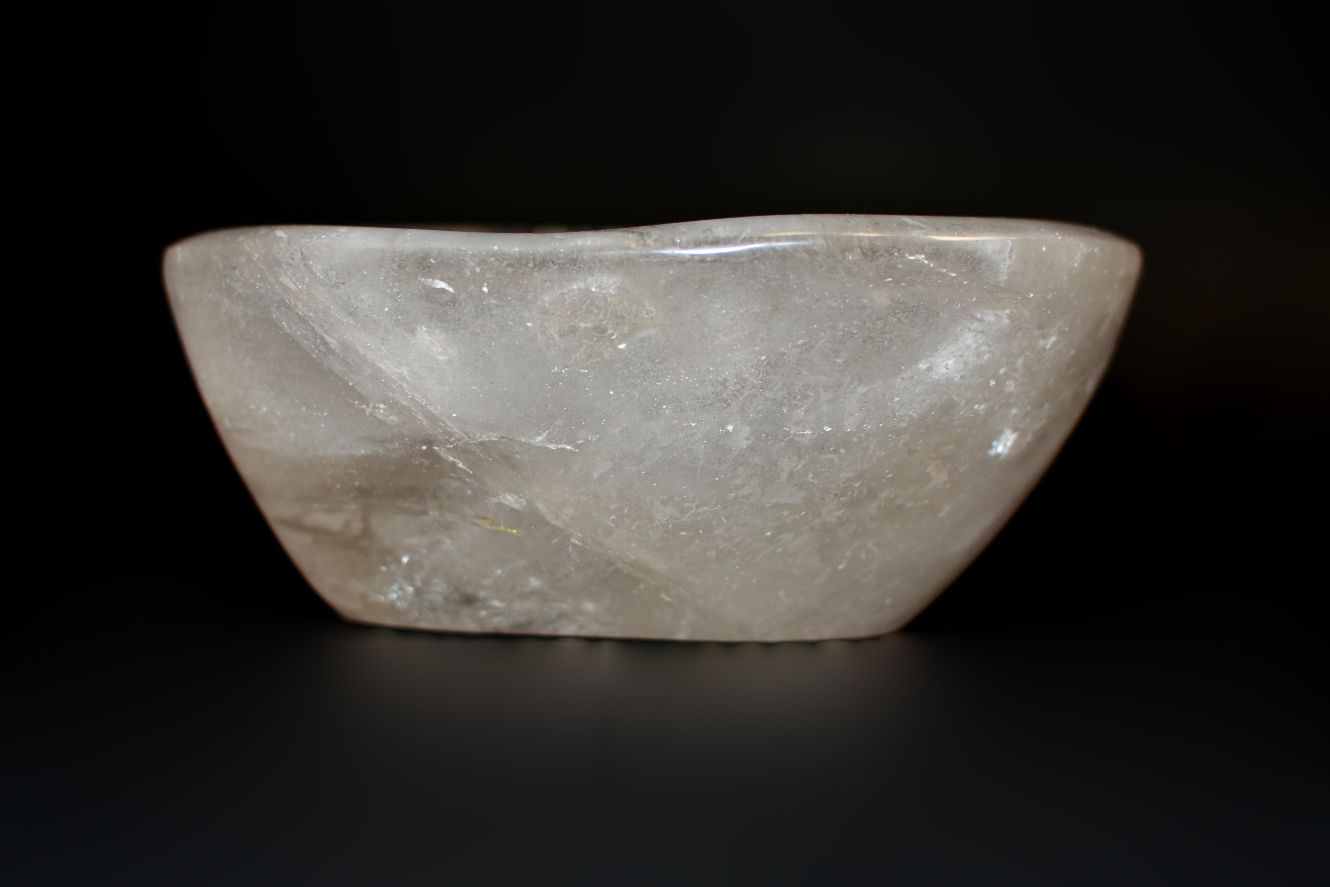 A beautiful crystal bowl made of all natural, fine grade rock crystal gemstone quartz. Of oval form and organic shape, with smooth edges and surfaces. Rare red and gold rutile and beautiful iridescence. Weighing at 3.4 lbs, this stunning piece will