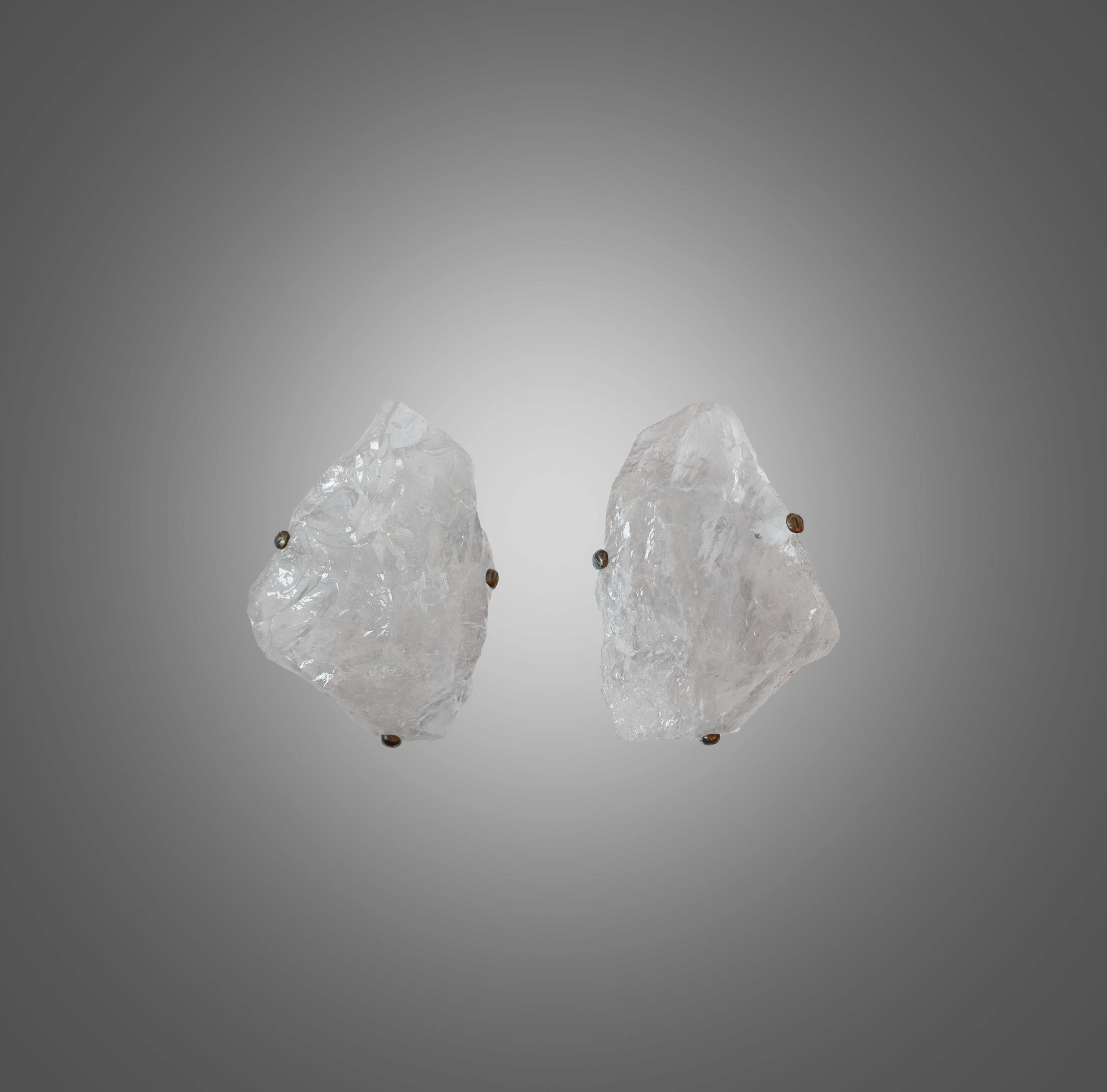 Pair of natural rock crystal quartz wall sconces with antique brass-mounted, selected from natural rock crystal with the beautiful natural surface. Created by Phoenix gallery.
Each wall sconce is installed with two sockets. 60 watts max each